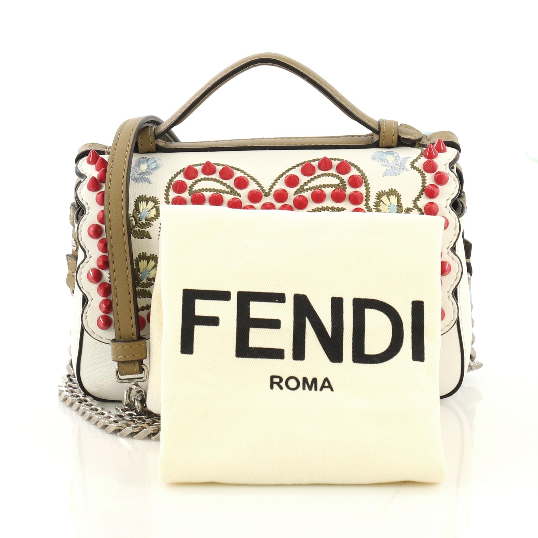 This Fendi Double Baguette Embroidered Studded Leather Micro, crafted from white and light blue leather, features embroidered and studded detailing, leather top handle, two micro baguette-shaped compartments, FF logo, and silver-tone hardware. Its