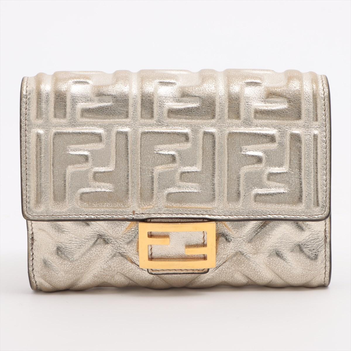 The Fendi Embossed Zucca Laminated Leather Bifold Wallet in Silver is a sleek and sophisticated accessory that exudes luxury and style. Crafted from high-quality laminated leather, the wallet features Fendi's iconic Zucca pattern embossed