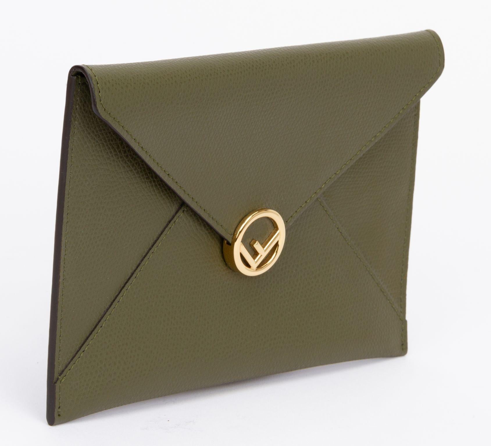 Fendi Calfskin medium flat envelope pouch in olive green. This pouch is made of textured calfskin leather. The top envelope flap snaps open to a matching leather interior. It closes with a push button which is gold and shows a circled F. The piece