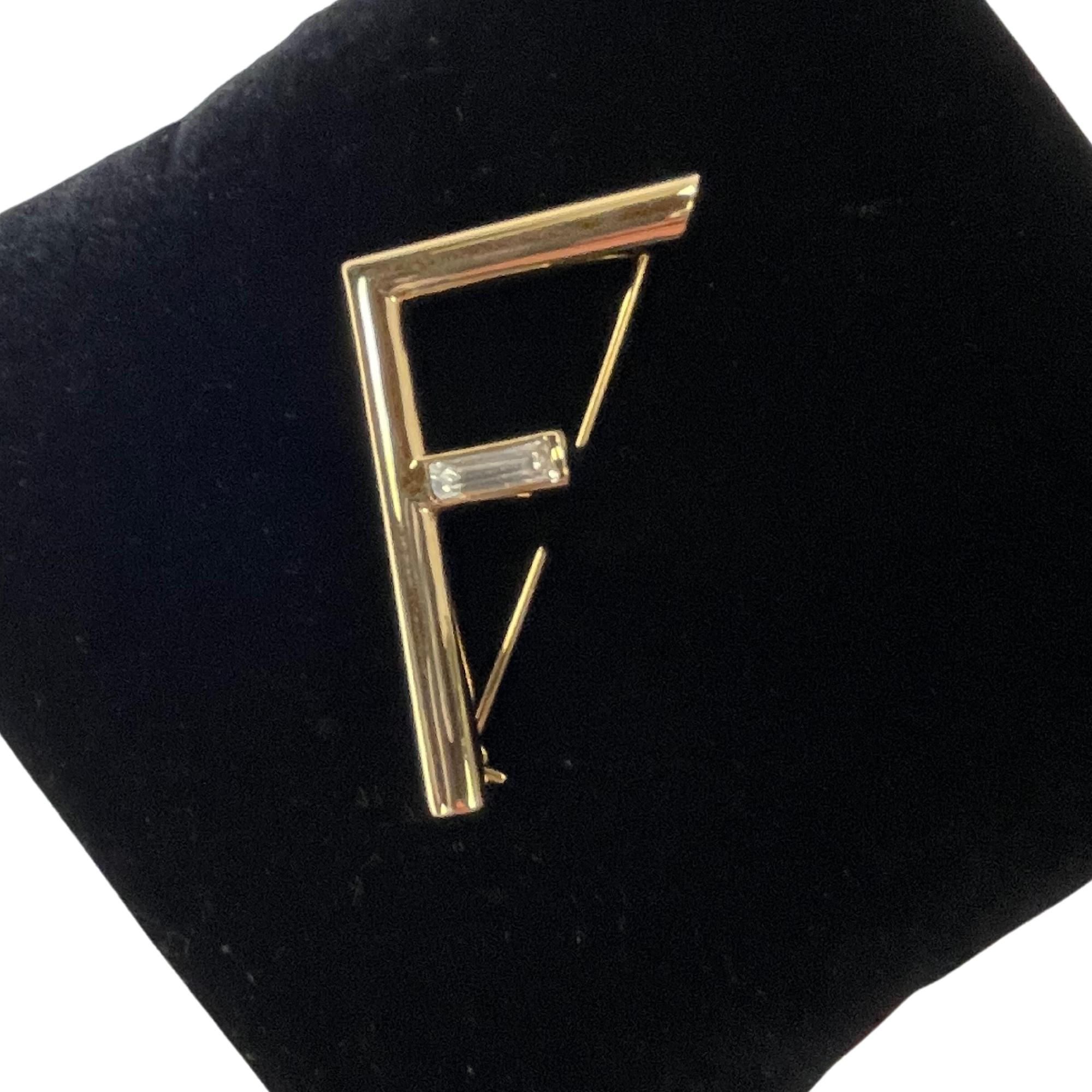 FENDI F GOLDTONE METALLIC BROOCH

Color: Gold tone
Material: Metalic
Marks:  Brand name & Made in Italy
Clasp Style: Pin

Measures: 2” x 1.6”
Comes with: Box
Condition: Very good. Like new with faint hairline scratches.

Made in Italy