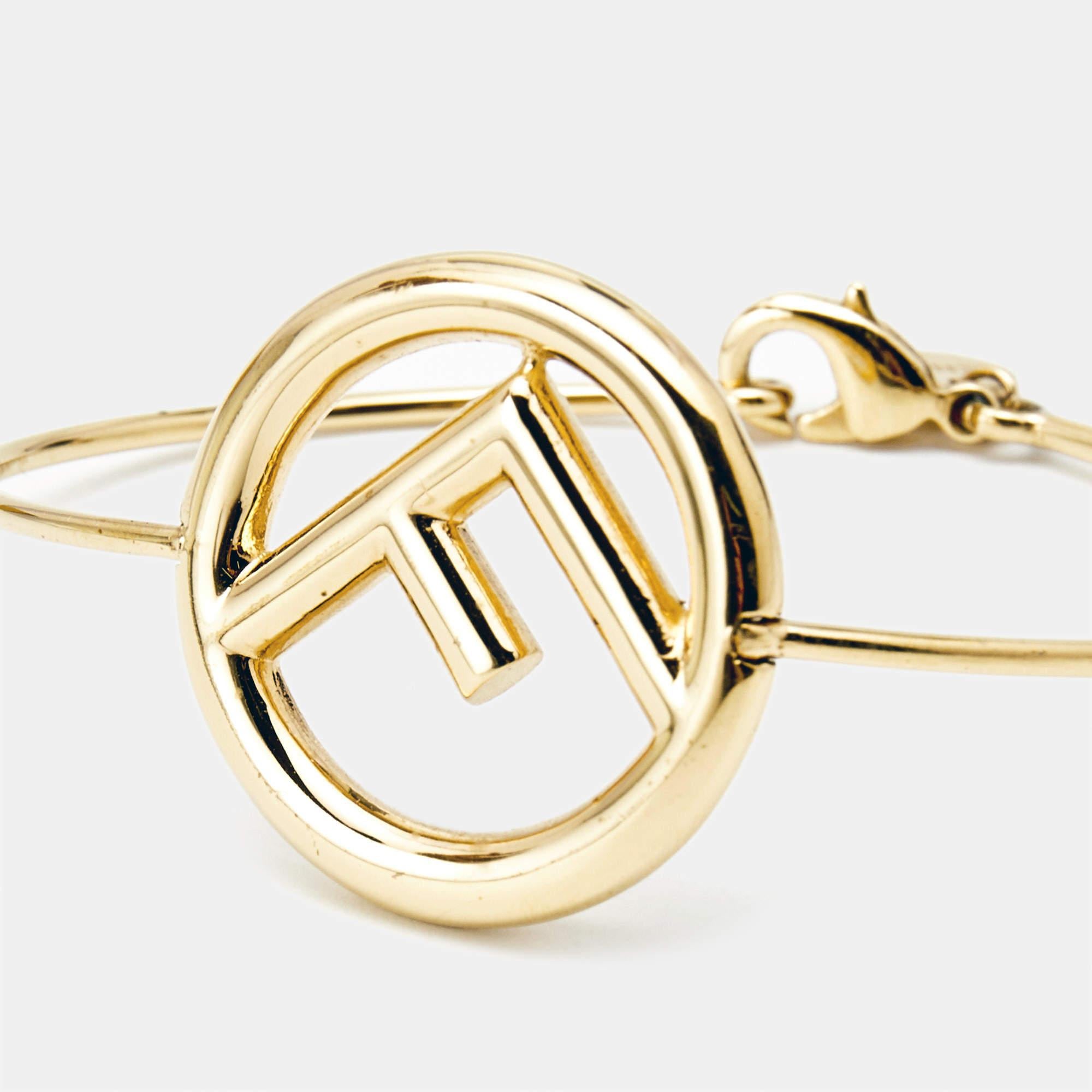 Dainty and beautiful, this 'F is Fendi' bracelet from Fendi is an outstanding piece worth adding to your accessories collection. It comes crafted from gold-tone metal and styled with the signature inverted F logo. It is fastened using a lobster