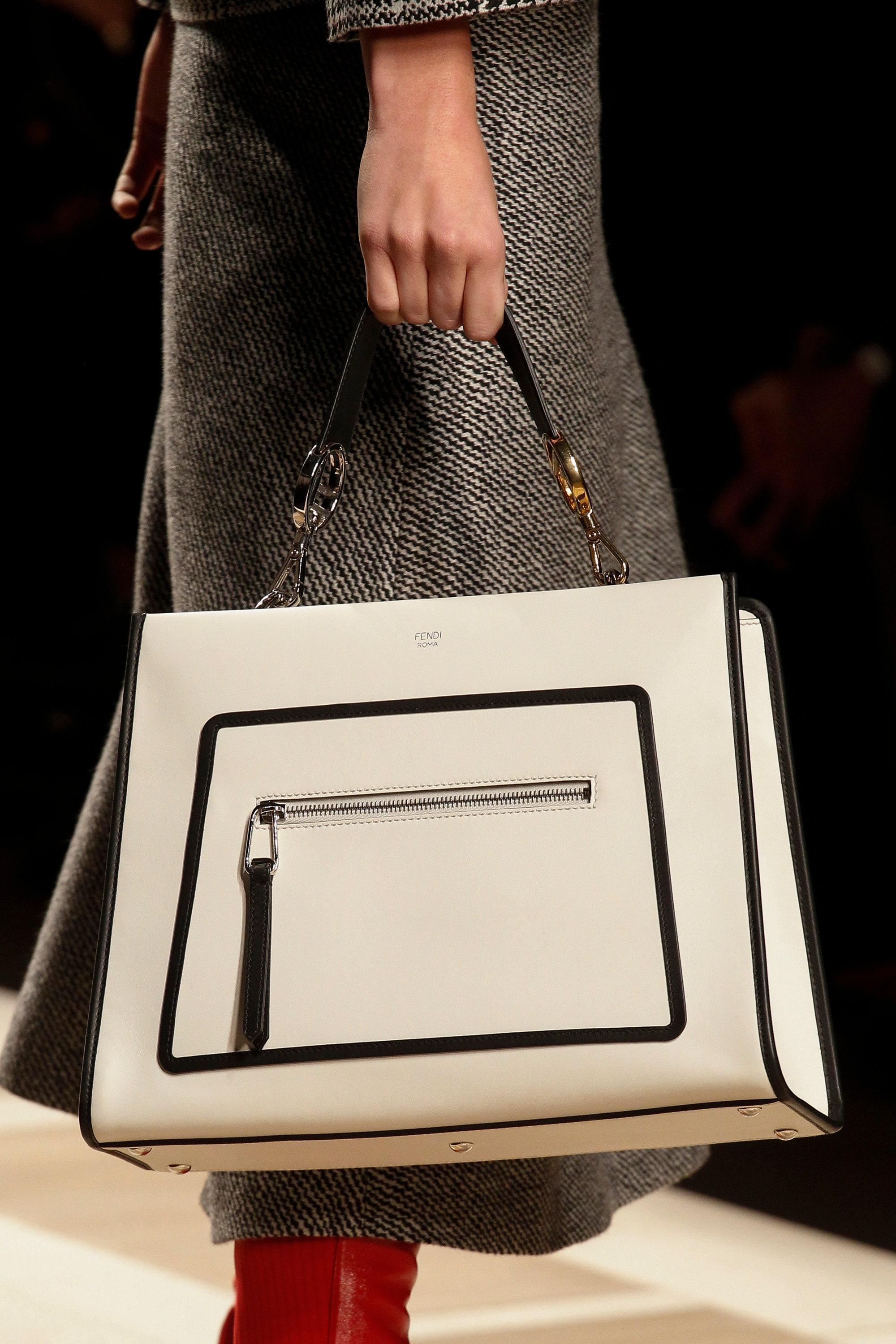 Fendi F/W 2017 Runaway bag
White and black leather
Mixed metals hardware
Outer pocket

Measurements: 
29x22x13 cm
handle drop 16 cm
crossbody strap drop 39.5-46.5 cm

11.5x8.5x5 in
handle drop 6 in
crossbody strap drop 15.5-18.25 in

Good