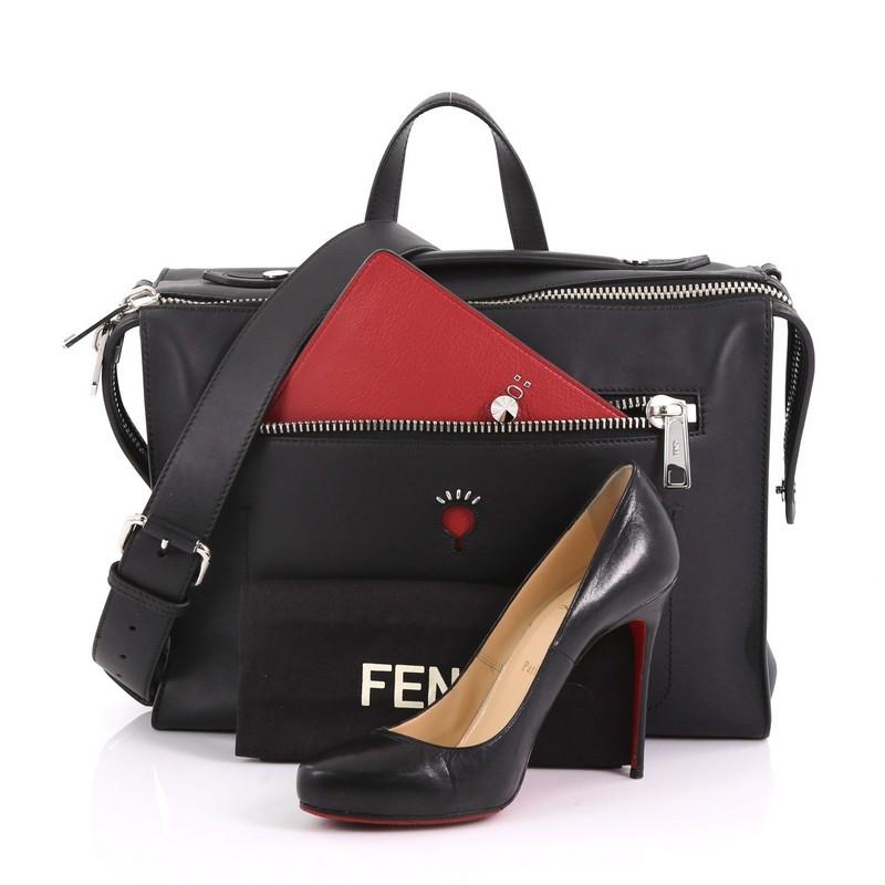 This Fendi Fendi Face Messenger Leather Large, crafted from black leather, features a leather top handle, exterior front pocket, and silver-tone hardware. Its zip closure opens to a black fabric interior with zip and slip pockets. **Note: Shoe