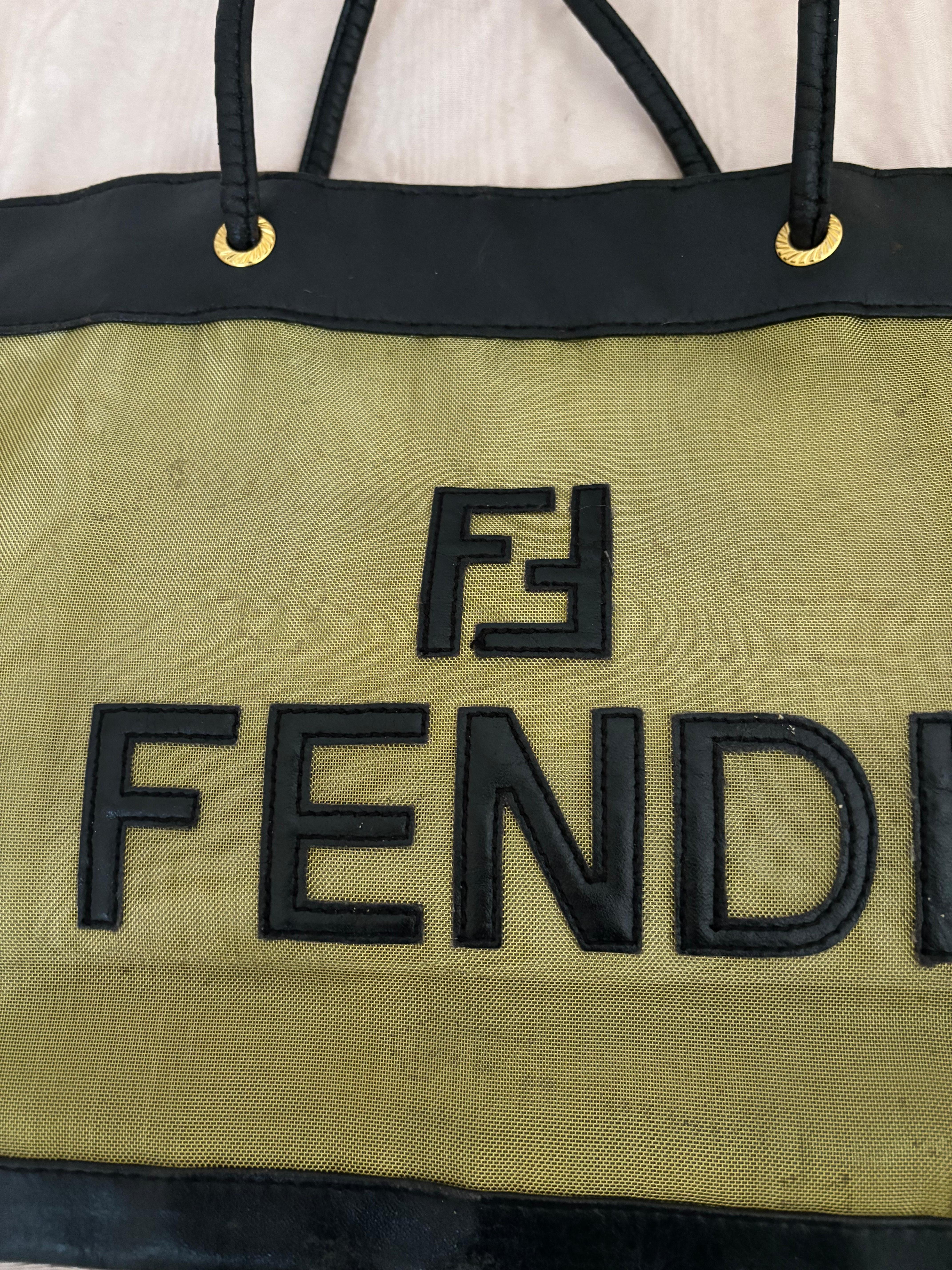 This unusual Fendi tote/shopper is made gold-tone woven mesh with leather trim all around  including the front applique Fendi logo and name. Pictures taken are with and without stuffing.
There are a few water marks which is why this item has been