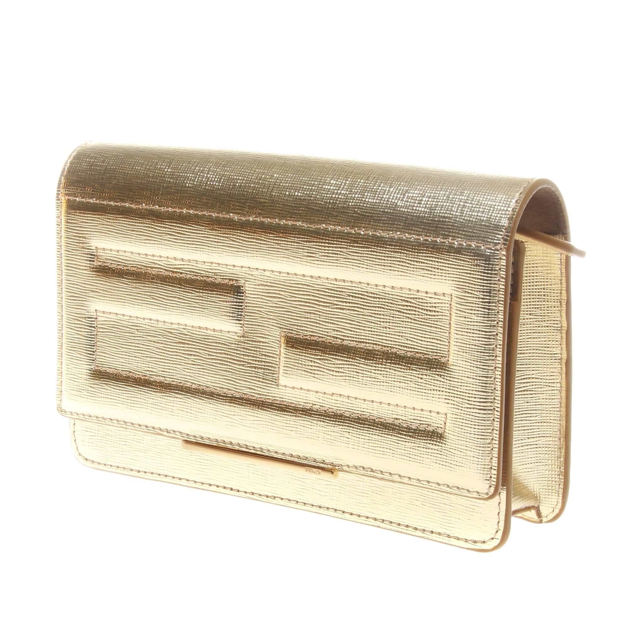 Fendi gold metallic calfskin wallet on chain (WOC). Tube design featuring FF stitching to front flap. 

The interior has handy gusseted compartments, flat pockets and six credit card slots.
Long detachable chain shoulder strap and gold metal ware.
