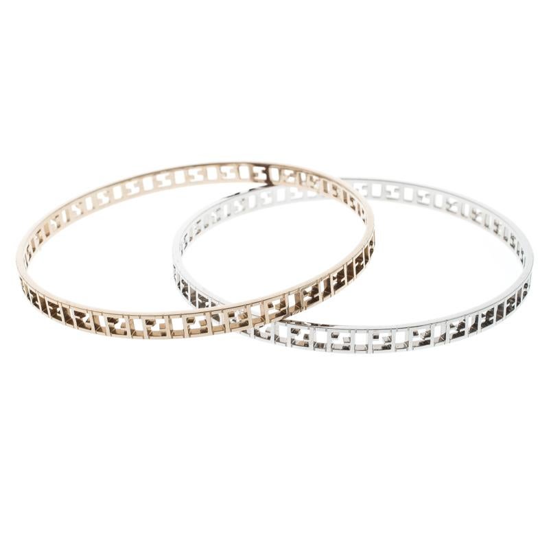 The Fendi bangle set features two slender bangle bracelets rendered silver tone and gold-tone metal each. They are designed with Fendi logo cutouts all over. Can be worn together or solo in turns with multiple outfits.

Includes: Original Box,