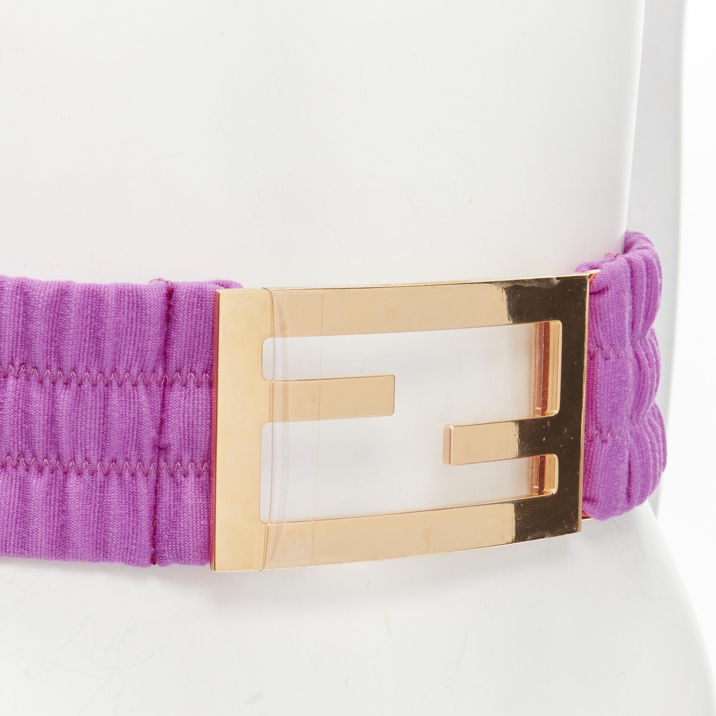 FENDI FF Zucca Baguette gold metal buckle purple stretch statement belt
Brand: Fendi
Material: Cotton
Color: Purple
Pattern: Solid
Closure: Hook & Eye
Extra Detail: Gold-tone FF buckle. Elasticated wide cotton belt. Hook bar closure.
Estimated