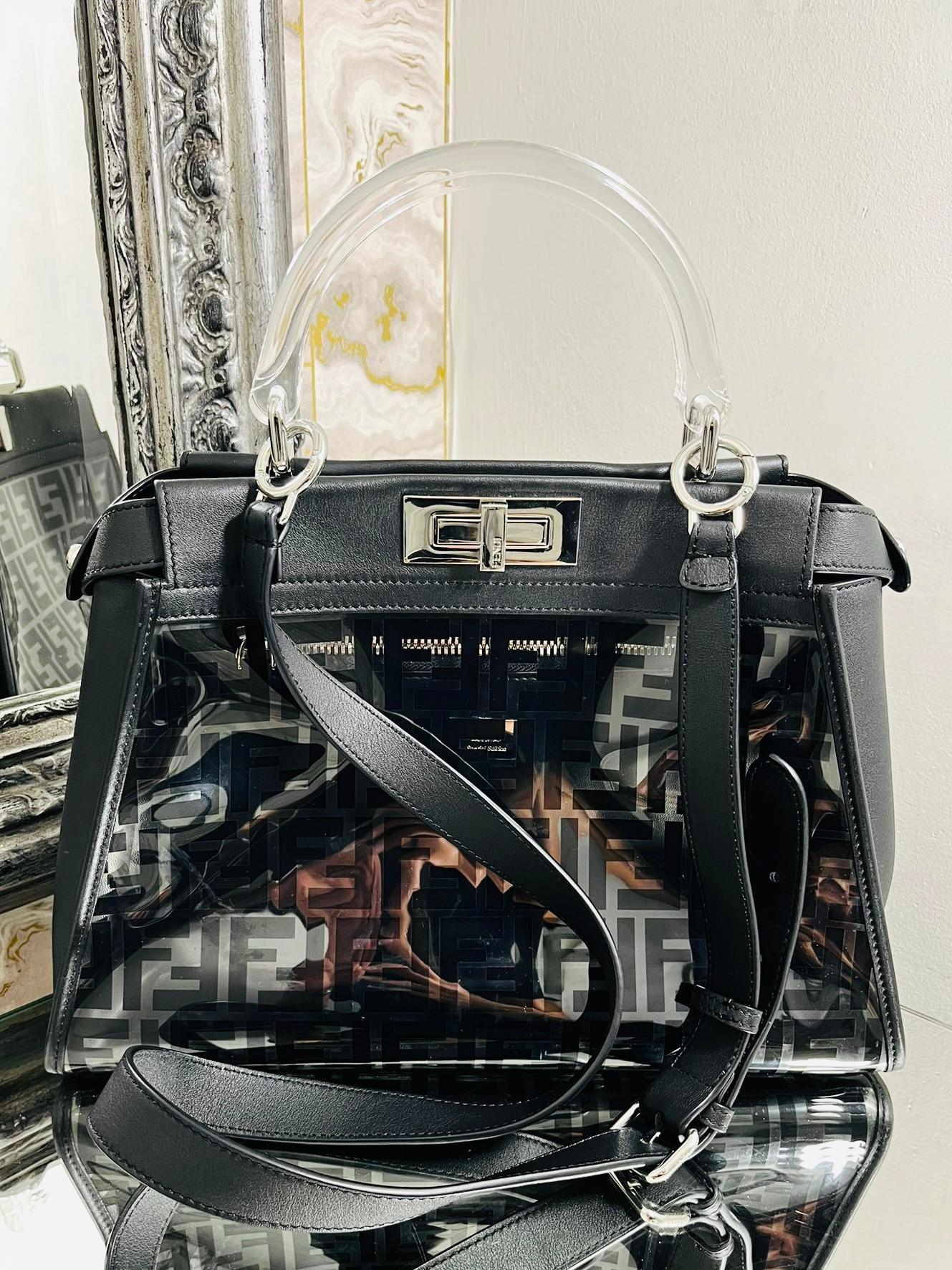 Fendi 'FF' Zucca Logo PVC Peekaboo Bag

Transparent PVC outer with large black 'FF' logo through out.

Acrylic transparent top carry handle, silver hardware, black leather accents

and a removable shoulder/crossbody strap. Fendi logo twist lock