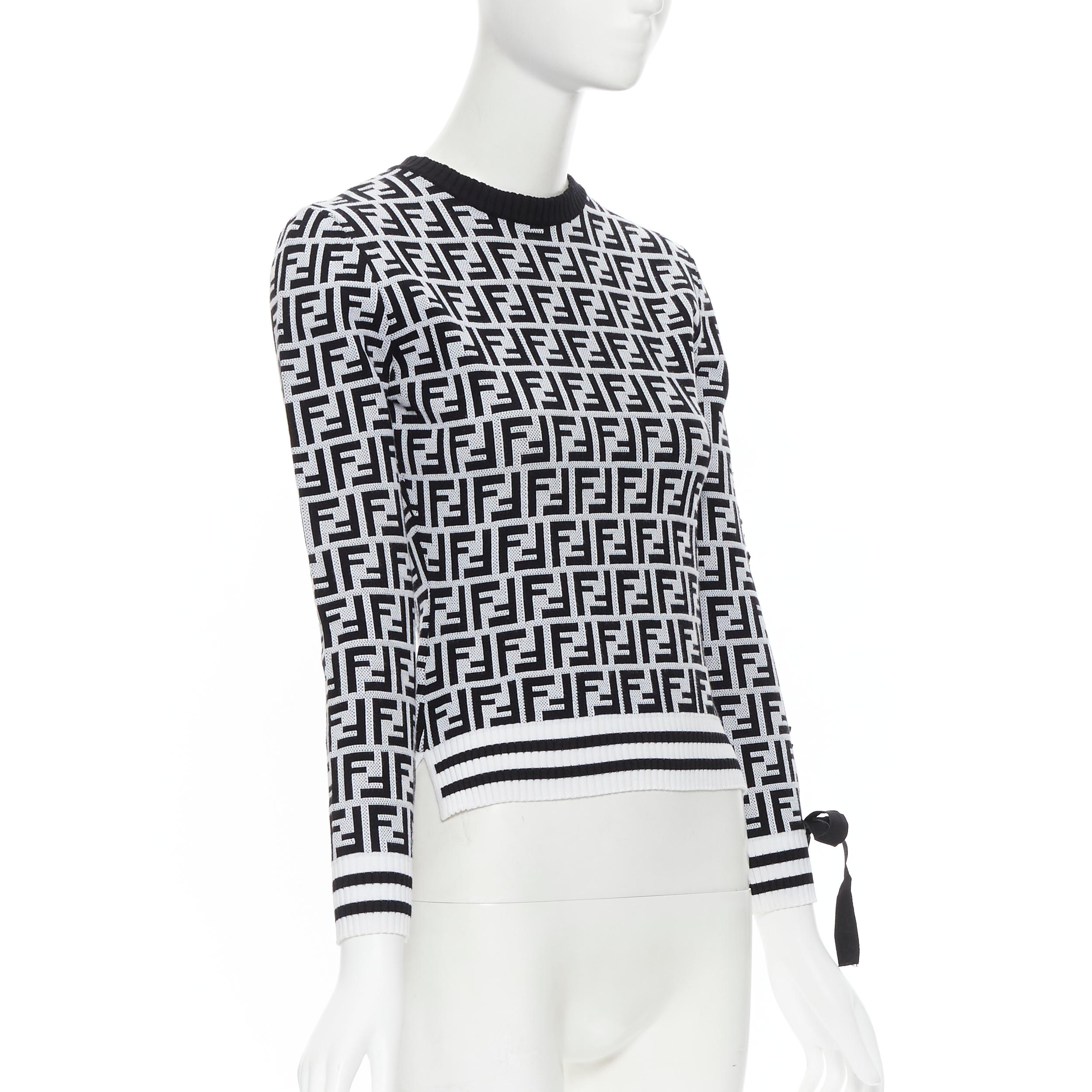 FENDI FF Zucca monogram black white ribbon laced sleeve sweater IT36 XXS Reference: TGAS/B01053 
Brand: Fendi 
Material: Viscose 
Color: Black 
Pattern: Abstract 
Extra Detail: Ribbon lace detail along left sleeve. 
Made in: Italy 

CONDITION: