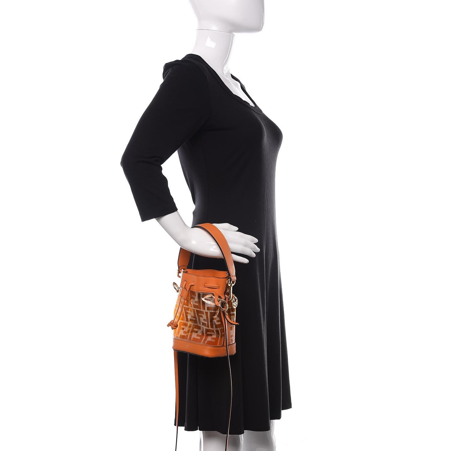 FENDI FF ZUCCA TPU ORANGE MON TRESOR BUCKET BAG MINI

This Fendi Mini Mon Tresor Bucket Bag is made from transparent TPU with the iconic Zucca print in orange. It features Vitello leather trim and details in matching orange and gold hardware. The