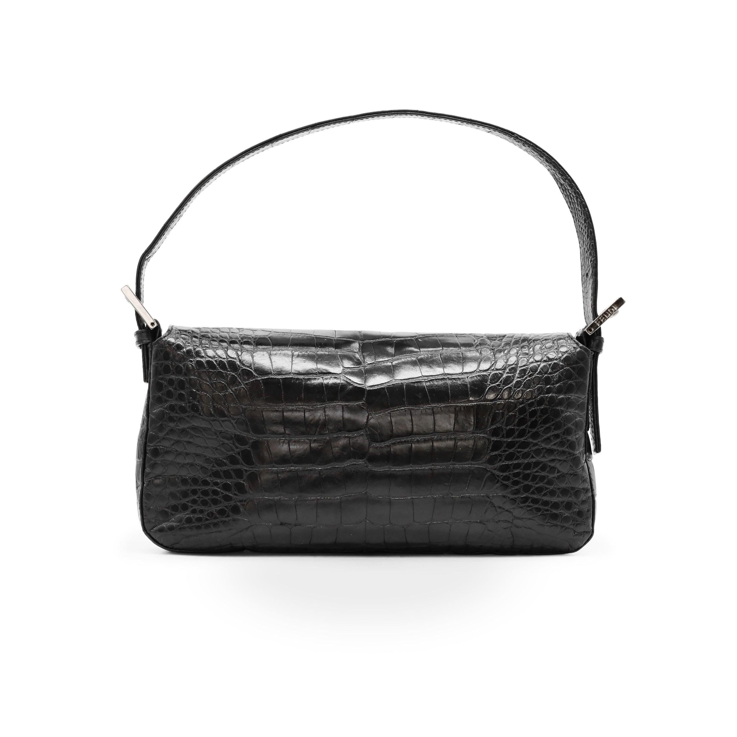 The Vintage Fendi Fibbia a Doppia F Baguette is a rare and exquisite piece, showcasing timeless luxury. Crafted from glossy crocodile leather, this iconic Fendi baguette bag boasts impeccable craftsmanship and a distinctive design. Featuring the