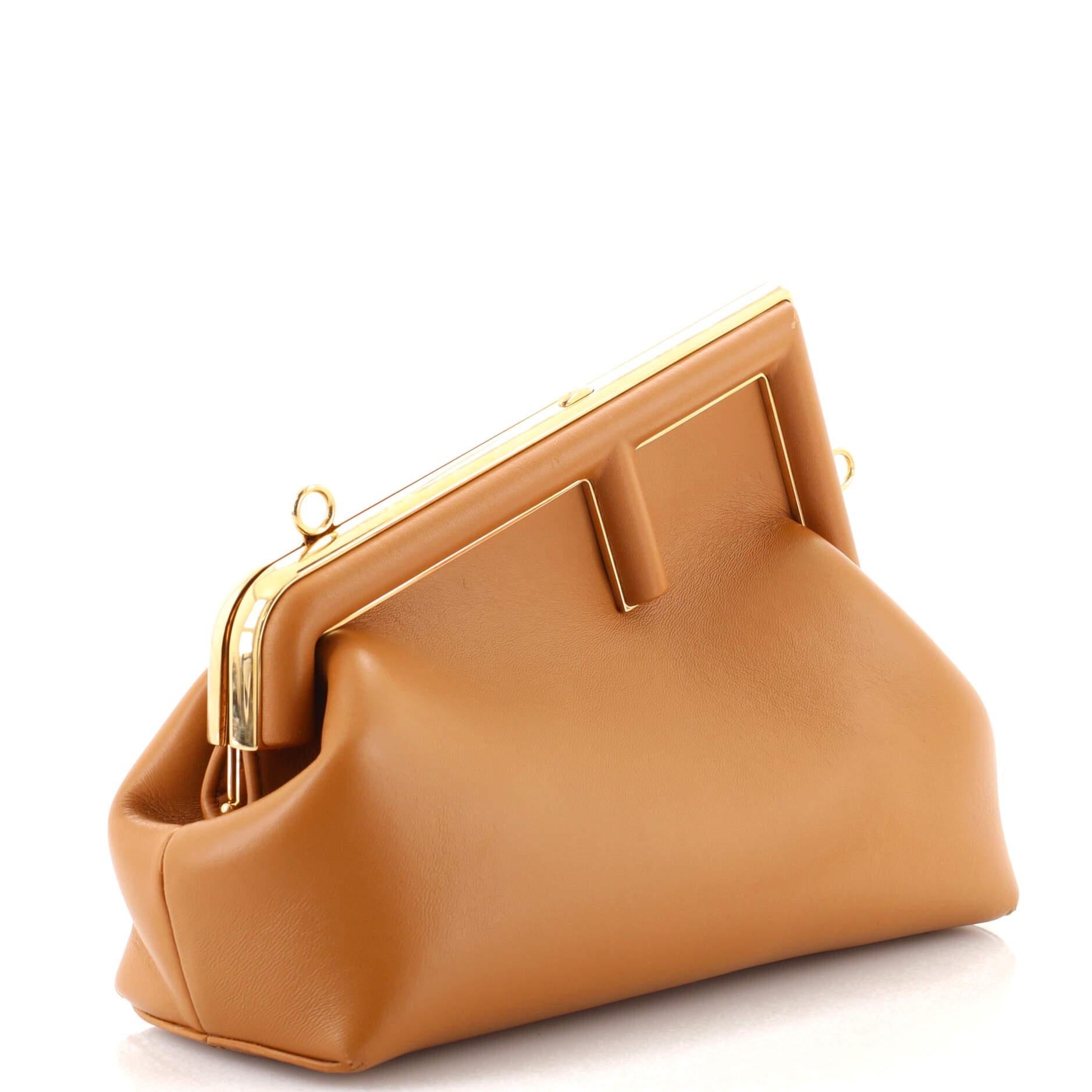 Condition: Very good. Wear on base corners, scuffs, indentations and minor creasing on exterior, peeling on opening corners. Wear and creasing on strap, scratches on hardware.
Accessories: With Strap
Measurements: Height 6.5