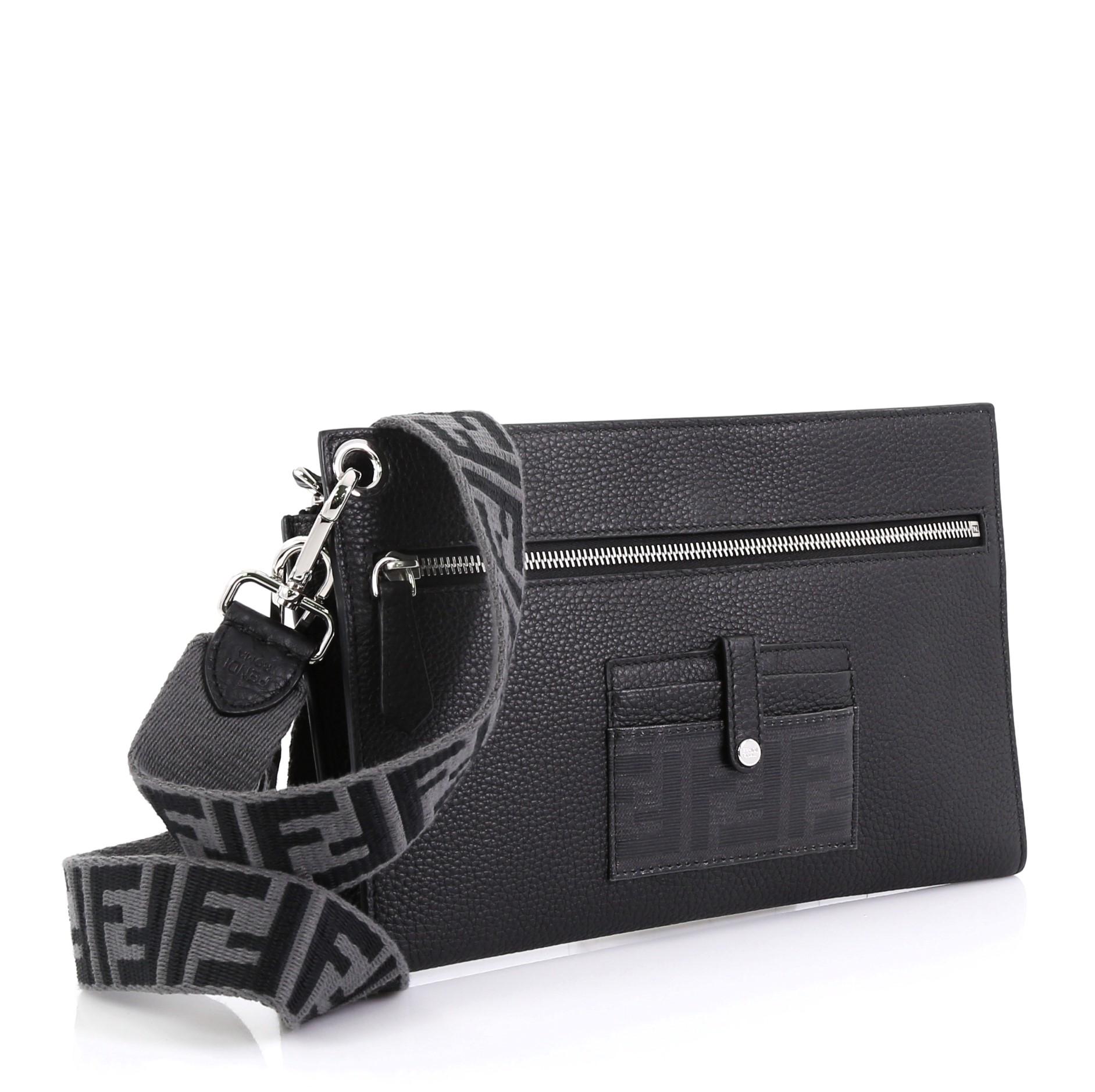 This Fendi Flat Pouch Crossbody Bag Leather Medium, crafted from black leather, features a detachable shoulder strap, front zip pocket, and silver-tone hardware. Its snap button closure opens to a black leather interior with multiple card slots and