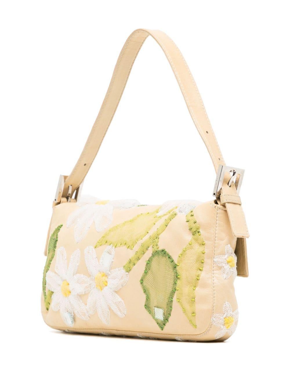 Enhance your vintage style this season with the iconic Fendi Floral Embroidered Baguette. Inspired by the French women carrying baguette bread under their arms, this trendy baguette from Fendi is the perfect piece for spring.

* Yellow leather
* FF