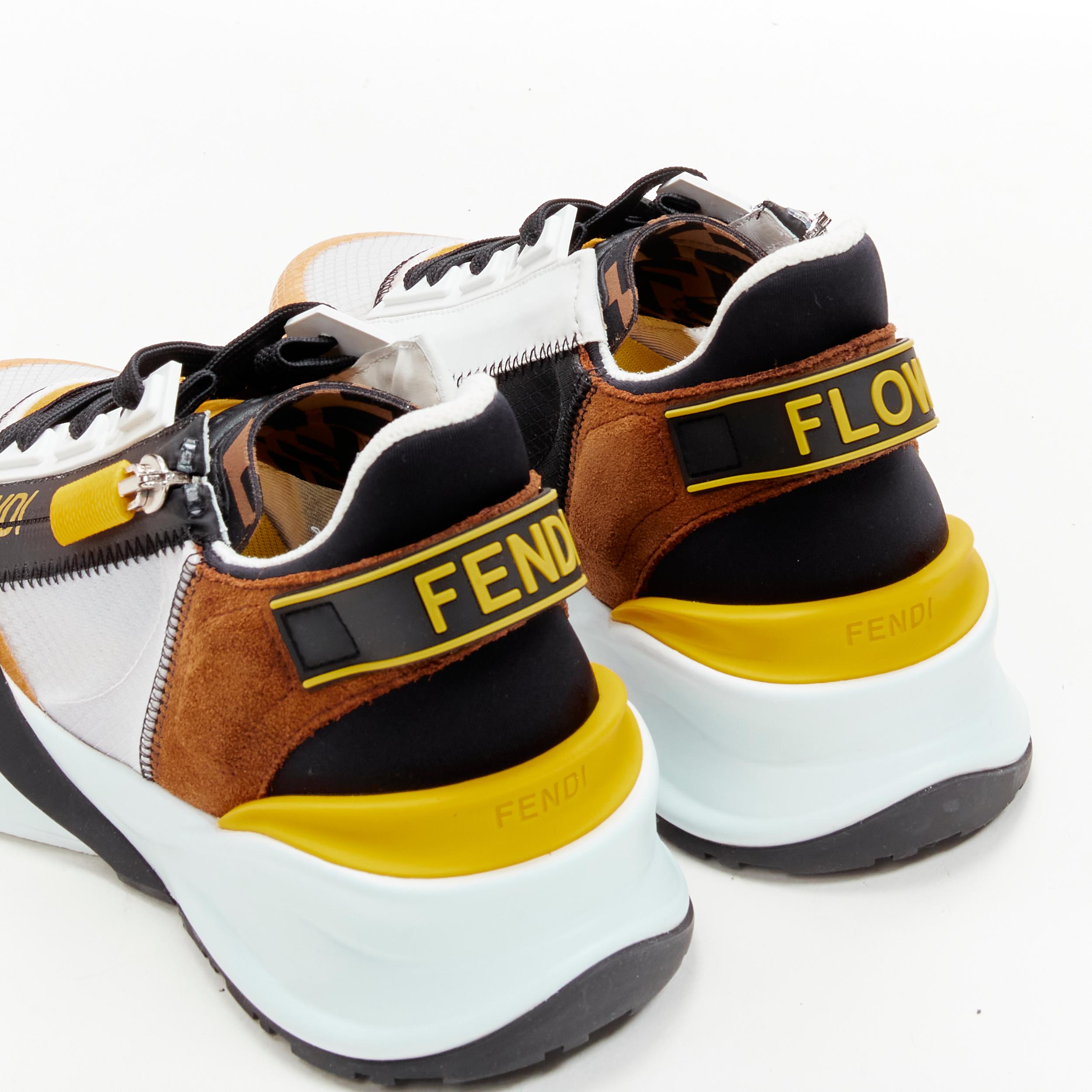 FENDI Flow white yellow brown logo zip low top sneaker EU36 
Reference: ANWU/A00357 
Brand: Fendi 
Collection: Flow 
Material: Fabric 
Color: Yellow 
Pattern: Solid 
Closure: Zip 
Extra Detail: Side zip closure. Flow rubber tag at heel. Chunky