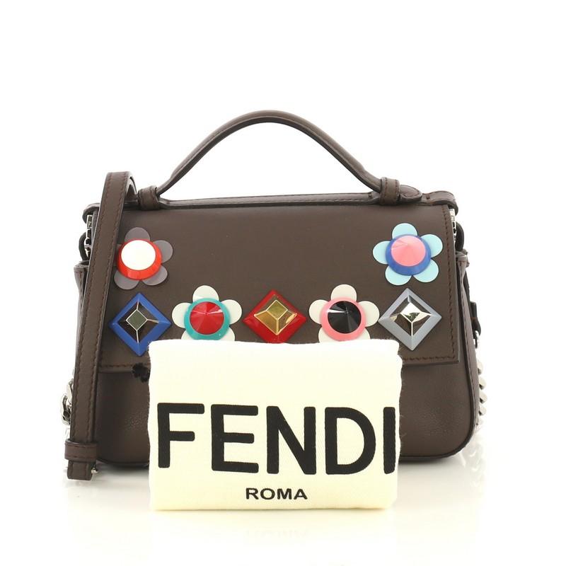 This Fendi Flowerland Double Baguette Crossbody Bag Embellished Leather Micro, crafted from brown and cream leather, features top leather handle, chain link strap with leather pad, ABS studded Flowerland appliqu̩es, and silver-tone hardware. Its