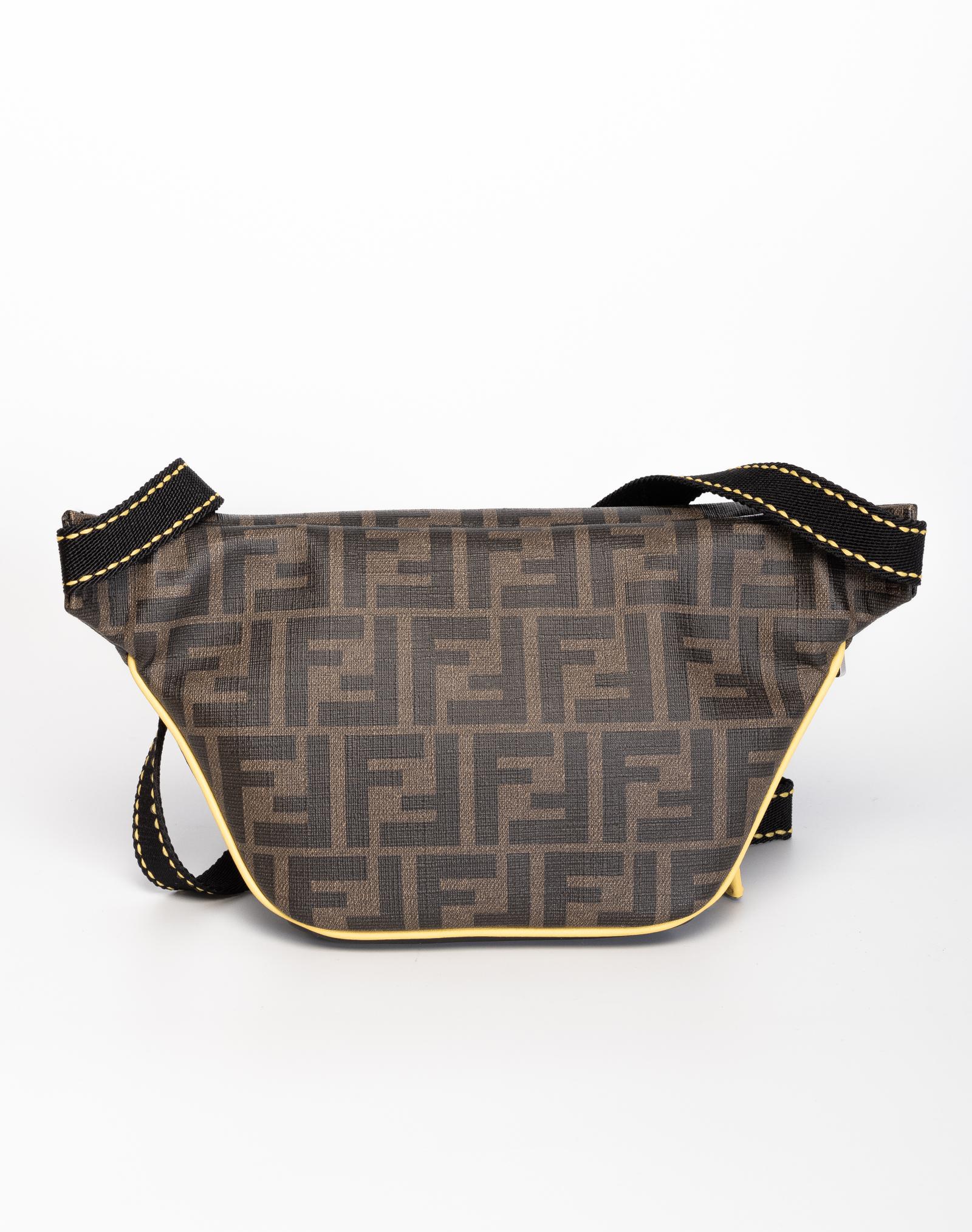 Forever Fendi belt bag made of canvas and soft calfskin with Zucca print and leather with silver hardware and yellow detail across the front. Zipper closure and an interior of yellow leather with a mesh slip pocket. Can be worn across the chest or