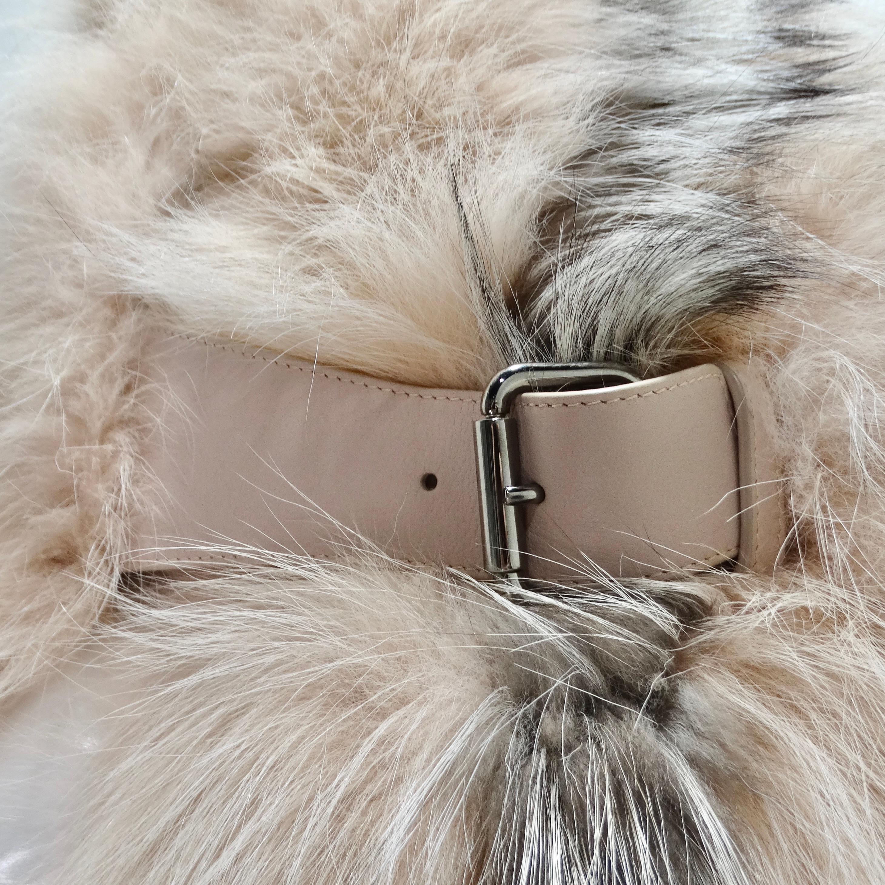 Introducing the Fendi Fox Fur Buckle Shawl—a luxurious and versatile accessory that seamlessly blends sophistication with a touch of edginess. The shawl features a combination of baby pink and brown fox fur, providing a plush and luxurious texture.
