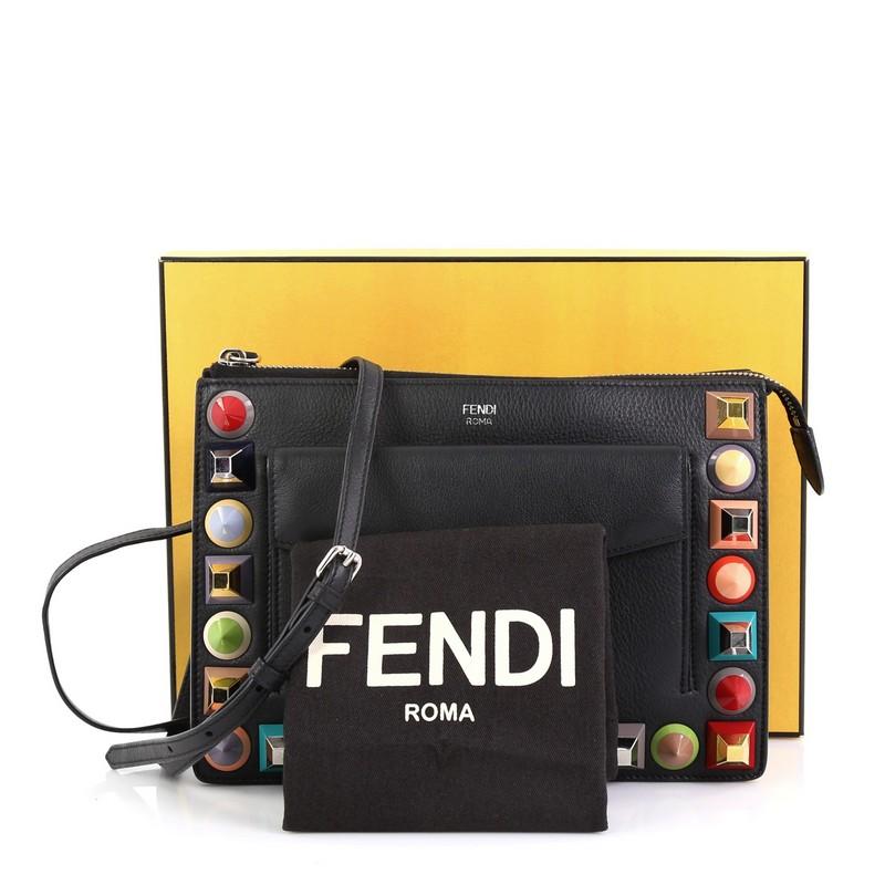 This Fendi Front Pocket Crossbody Bag Studded Leather Small, crafted from black studded leather, features an adjustable strap, exterior front flap pocket, and silver-tone hardware. Its zip closure opens to a black fabric interior.

Estimated Retail
