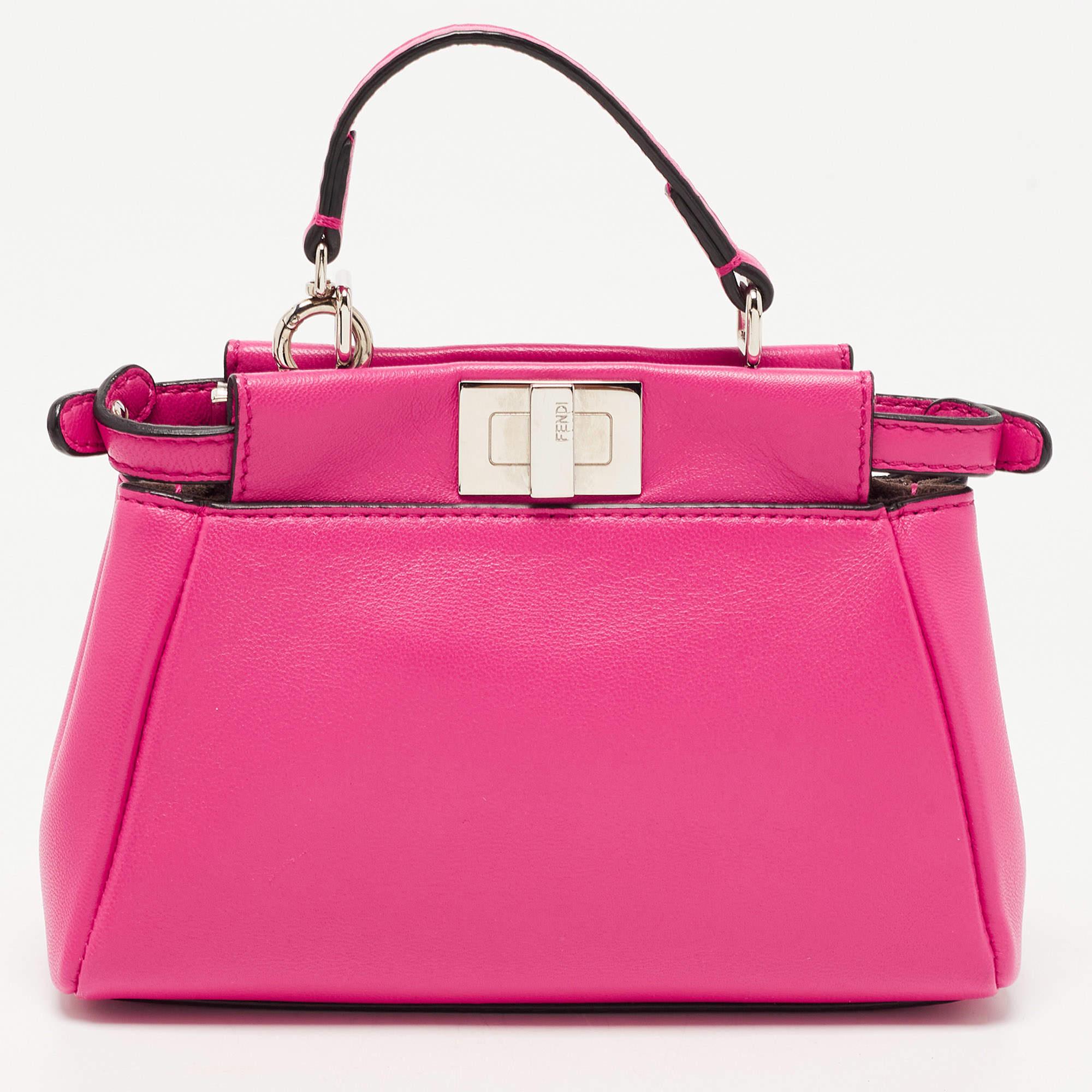 This sized-down version of the iconic Fendi Peekaboo will be a delight to carry. It is sewn using fuchsia leather and paired with gold-tone hardware. It may not house much, but it will surely advance your style!

Includes: Detachable Strap