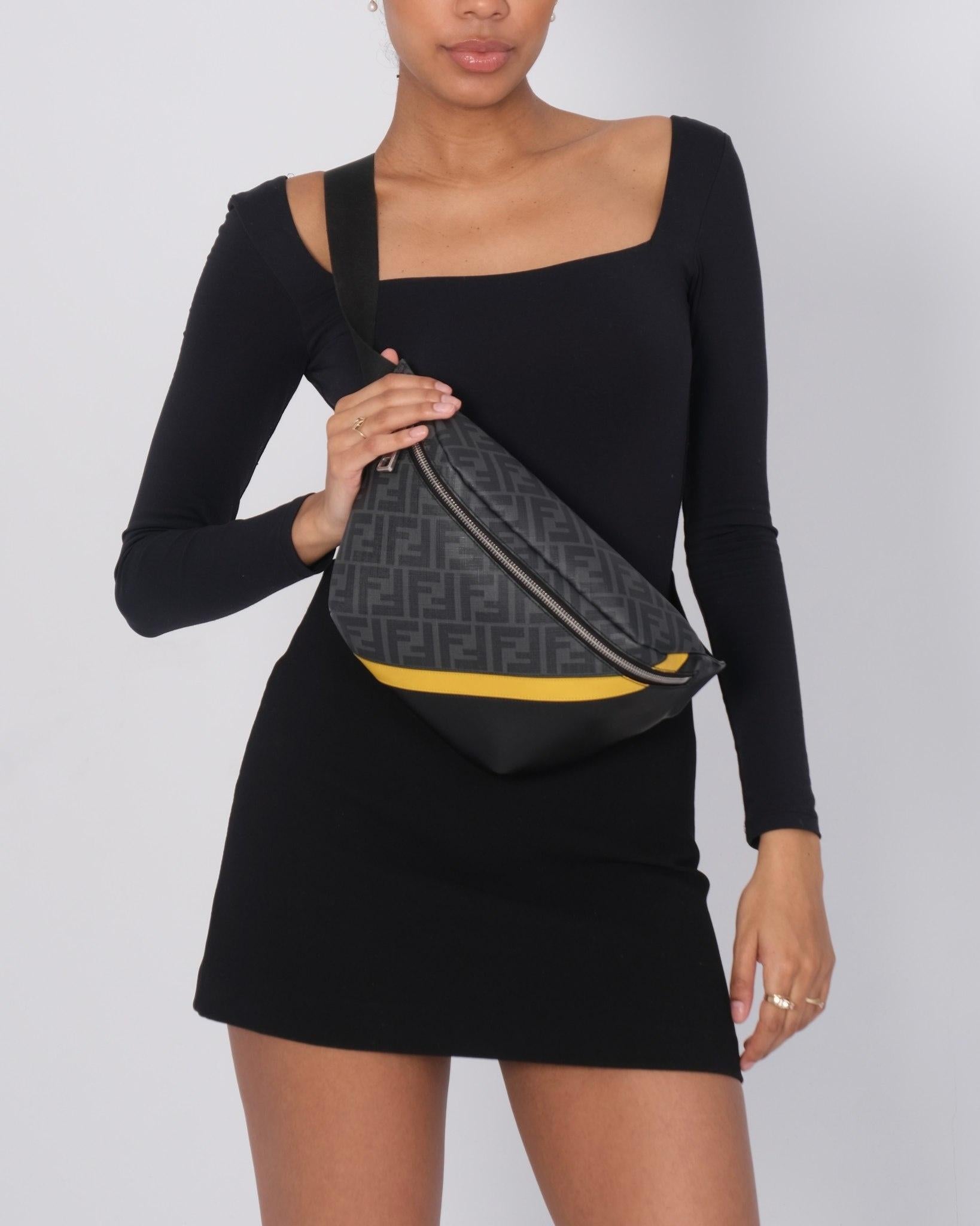 This belt bag is made of FF monogram glazed fabric crossed with vitello liberty leather in black. The bag features an adjustable waist-length cross-body shoulder strap with polished silver hardware. The zipper opens to a black fabric interior with a