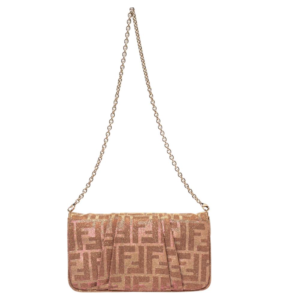 Complete a winning look with this Mia Pochette bag from the House of Fendi. It is made from gold/pink Zucca lurex fabric and has a gold-toned FF logo perched on the front. The interior is lined with satin.

Includes: Original Dustbag, Info Booklet