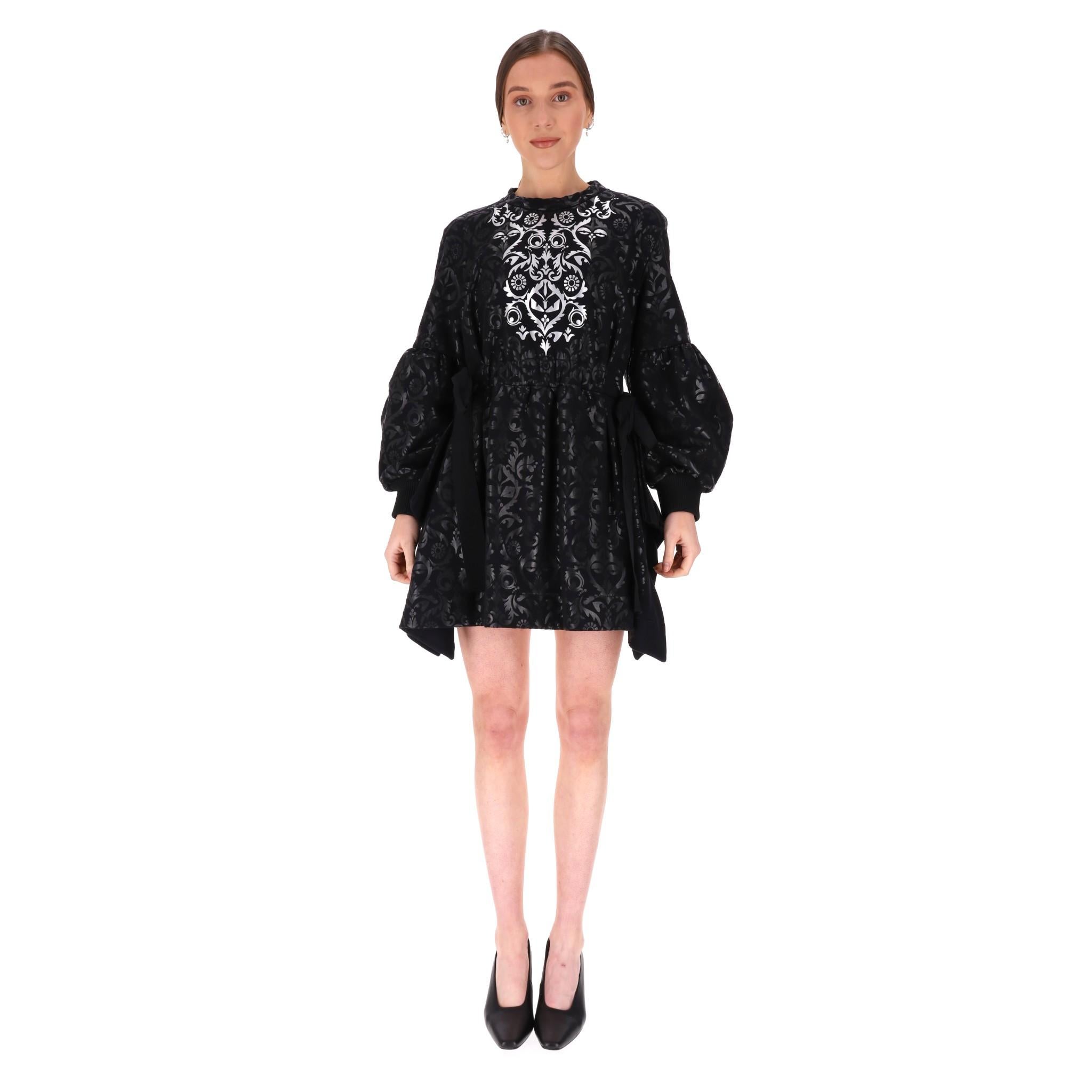 Fendi Gothic Print Verschönertes Kleid

Schwarzes Kleid mit Gothic-Muster und silbernem Muster auf der Brust.

Ballonärmel mit Stehkragen und plissierter Minirock.

Elastischer Bund mit beidseitiger Bindebandverzierung.

Preis ca. £2,500

Größe -