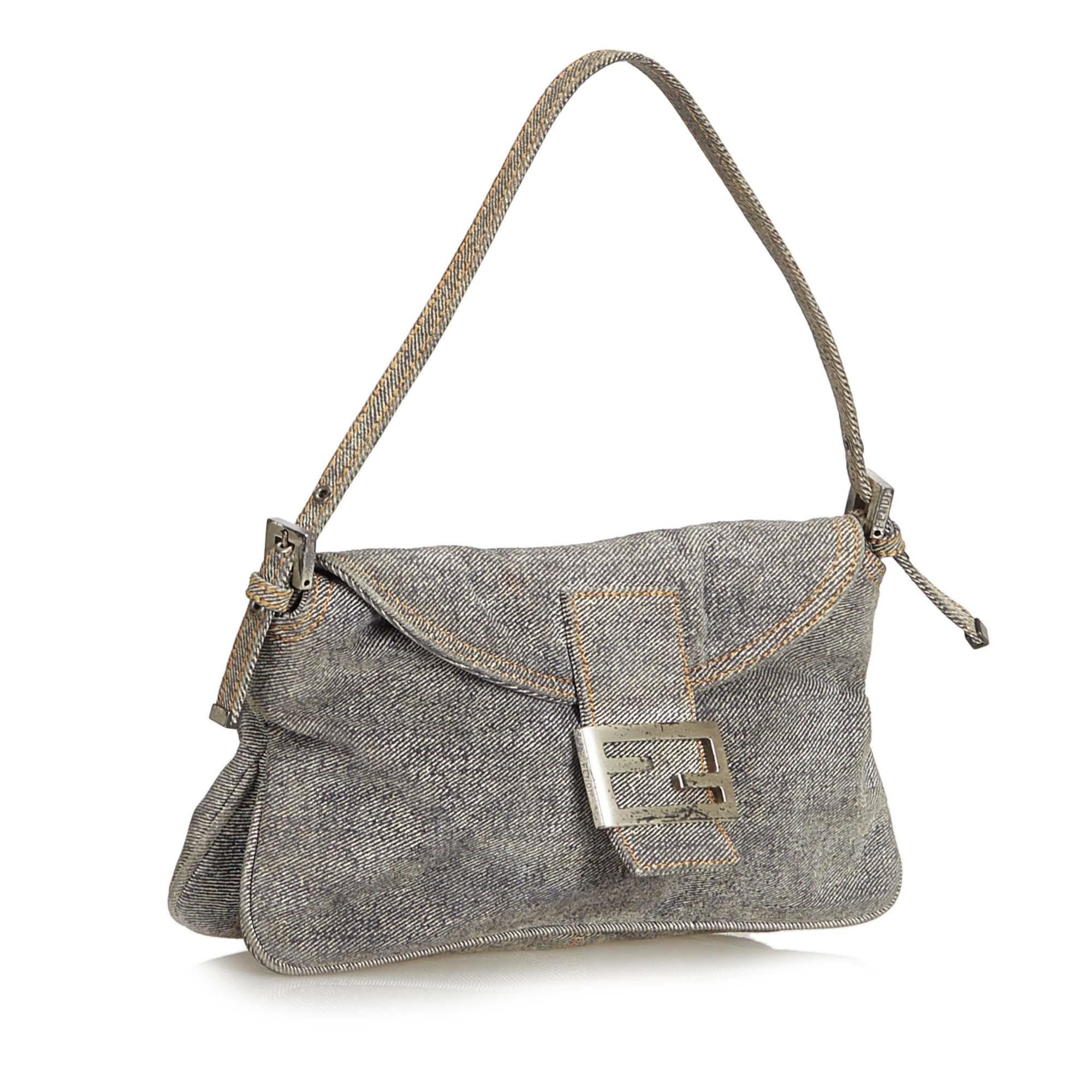 This baguette bag features a denim body, flat handle, front flap with magnetic closure, and interior zip pocket. It carries as B condition rating.

Inclusions: 
This item does not come with inclusions.

Dimensions:
Length: 13.00 cm
Width: 26.00