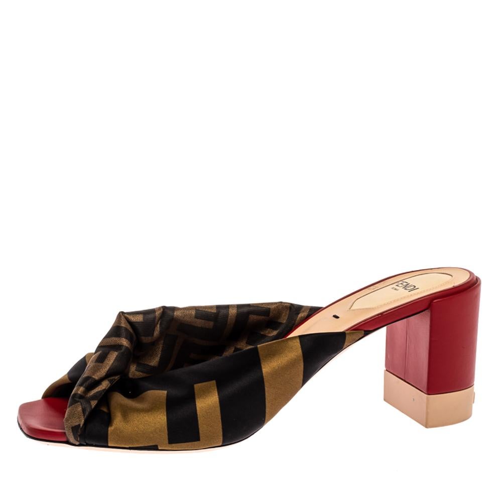 Richly detailed with contemporary aesthetics, these mules from Fendi are one of a kind. They have been crafted from logo printed satin into an open-toe silhouette and styled with twisted knots on the vamps. They are endowed with comfortable
