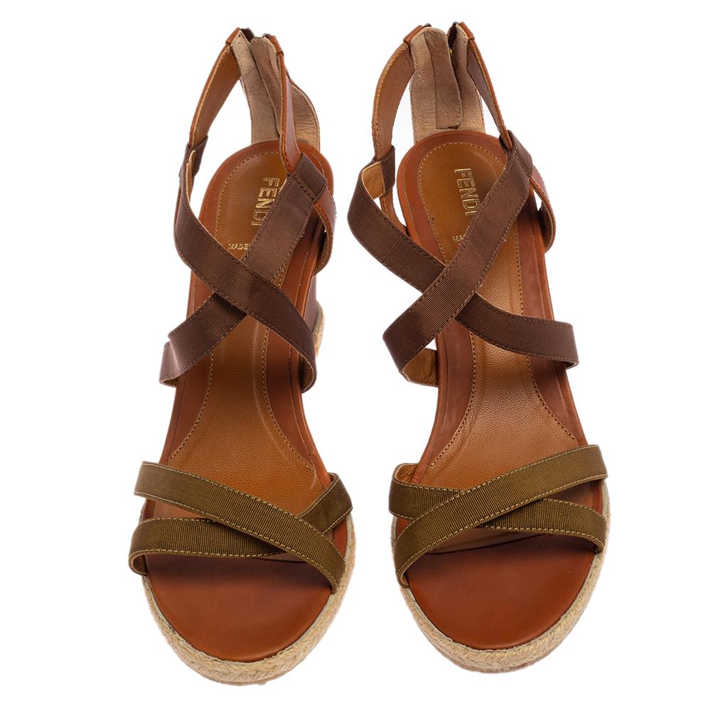 Simple, elegant, and comfortable, these Fendi sandals will make a fine addition to your shoe collection. They are styled with straps in fabric and leather, zip fastening at the counters, and wedge heels.


