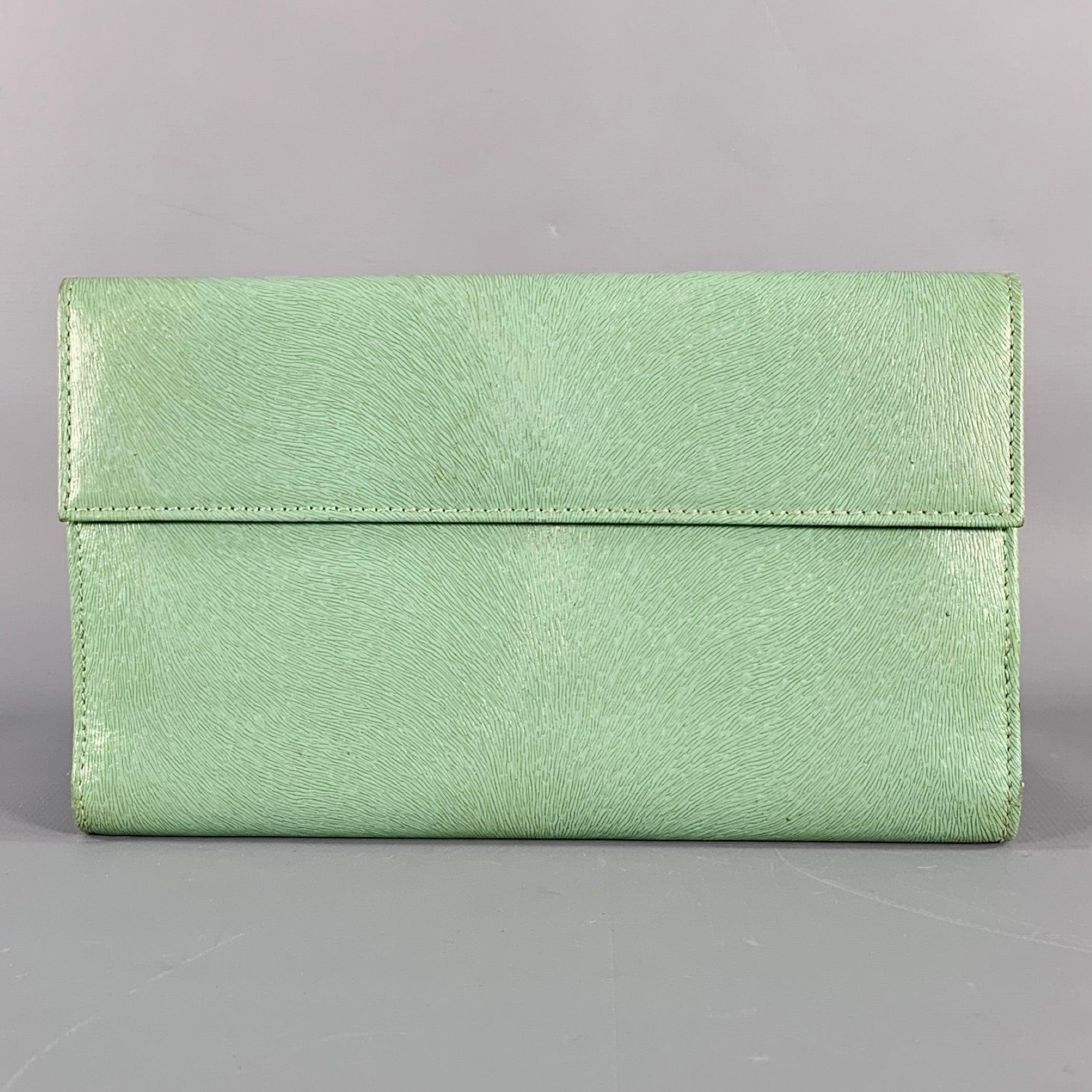 FENDI wallet
in a green embossed leather featuring nine card slots, gold tone metal logo detail, and snap closure. Made in Italy.Very Good Pre-Owned Condition. Signs of wear on corners. 

Marked:   2181567.5 X 4.5 inches 
  
  
 
Sui Generis