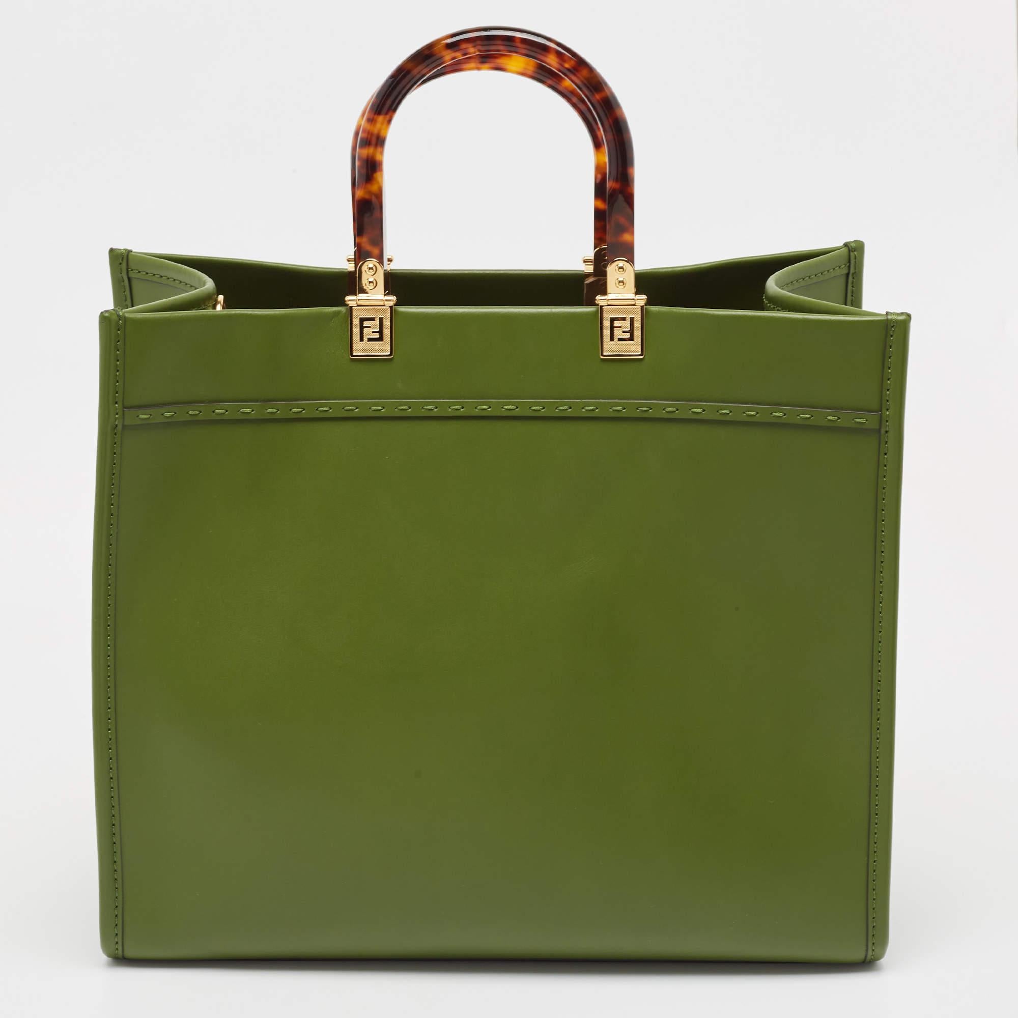 The Fendi Sunshine Tote is a luxurious and versatile handbag. Crafted from green leather, it features a spacious interior. The iconic Fendi logo is subtly embossed, and the bag is adorned with elegant gold-tone hardware.

Includes: Original Dustbag

