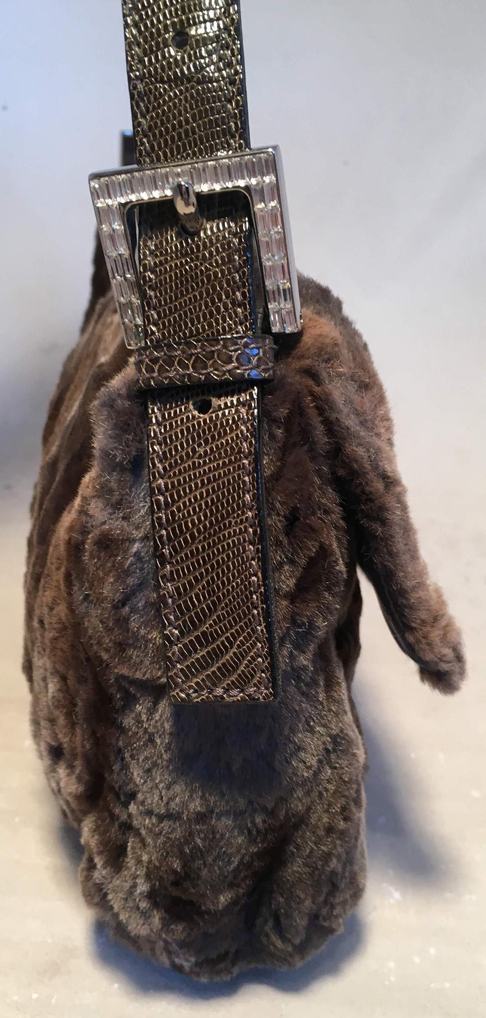 Fendi Green Mink Fur & Lizard Baguette in very good condition. Soft dark green and brown mink fur exterior trimmed with green lizard leather handle and front FF crystal adorned snap closure. Silver hardware throughout. Beige leather interior with