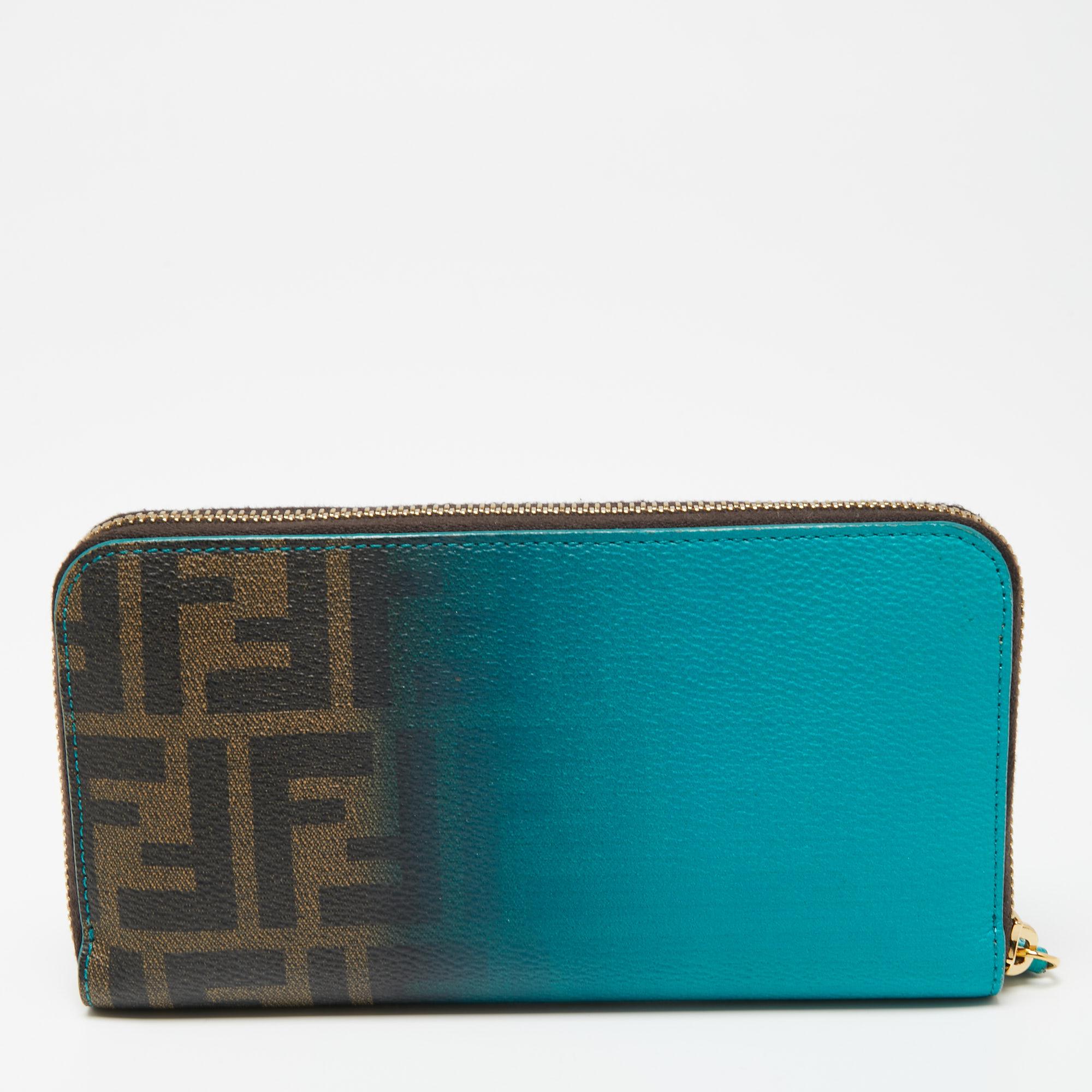 Add this classy Fendi wallet to your wardrobe and carry all your monetary essentials in style. It features a green ombre Zucca coated canvas exterior. The leather and fabric interior features multiple card slots and a zipped compartment. This piece