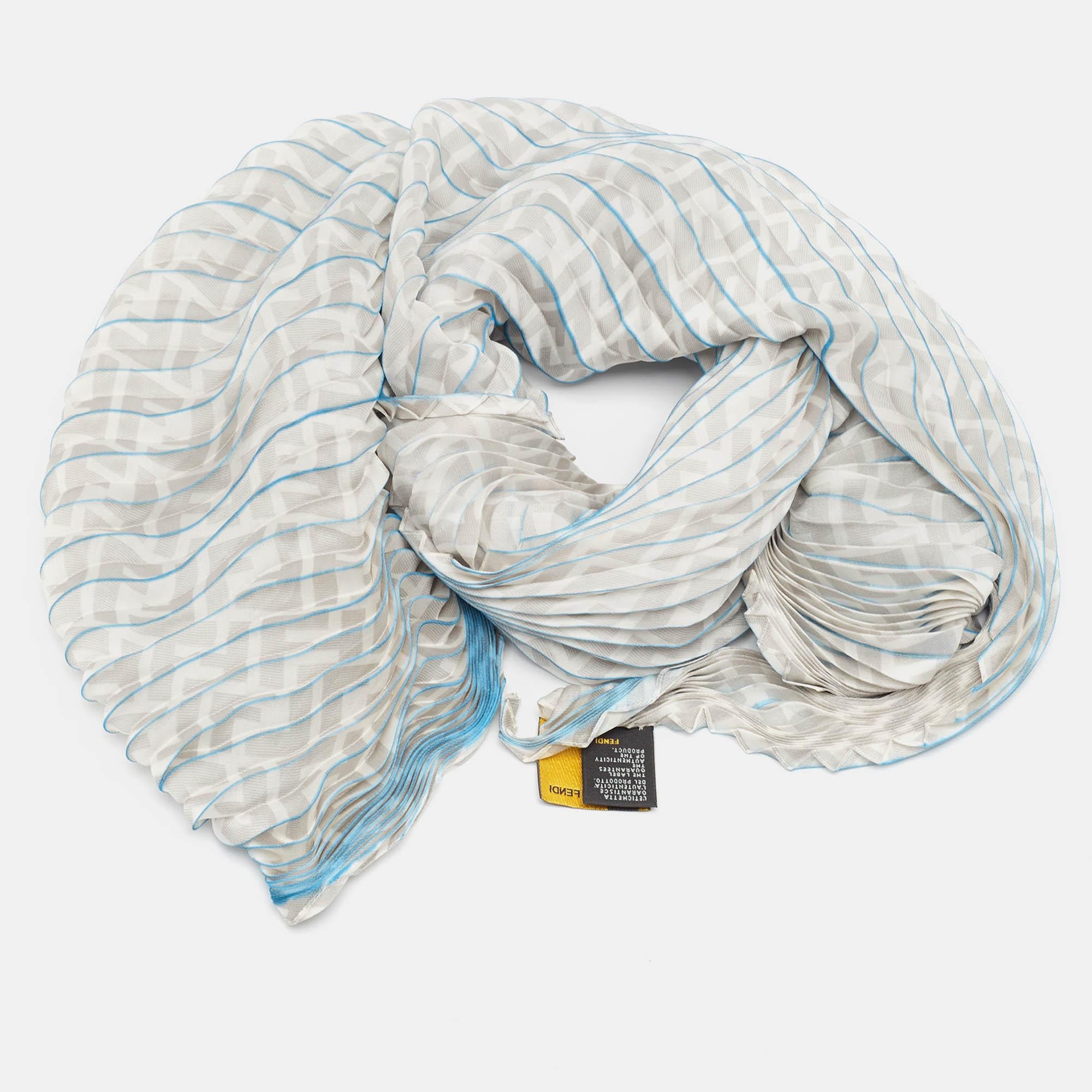 Discover the Fendi scarf a luxurious blend of sophistication and style. Crafted from exquisite silk this scarf features the iconic Zucca print in elegant grey and blue hues. Its plisse texture adds a touch of refinement making it a versatile