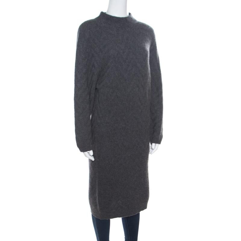 This lovely sweater dress from Fendi is perfect for the fashionable you! The grey creation is made of 100% cashmere and features a chevron patterned knit design. It flaunts a high neck and long sleeves. Sure to lend you a good fit, it can be paired