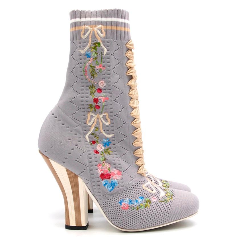 Fendi grey embroidered stretch knit ankle boots with openwork on the whole shoe, multicolour flower embroidery on the side, contrast striped heel, sock boot fit and ribbed edging and two-tone stripes on top of boot. 

Yarn

Season 2017.

Size IT