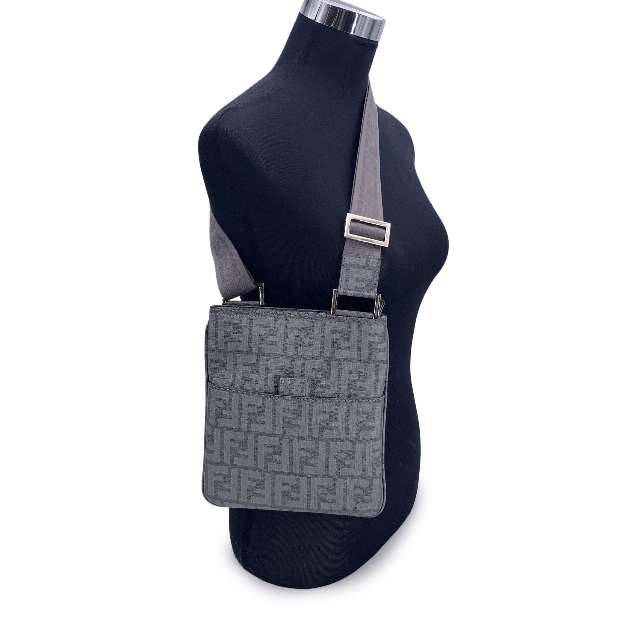A true icon from the golden era of logomania, this Fendi messenger bag is a love letter to early 2000s fashion-practical, bold, and effortlessly stylish. Crafted from the brand's signature grey Zucca FF monogram canvas, it features a front pocket