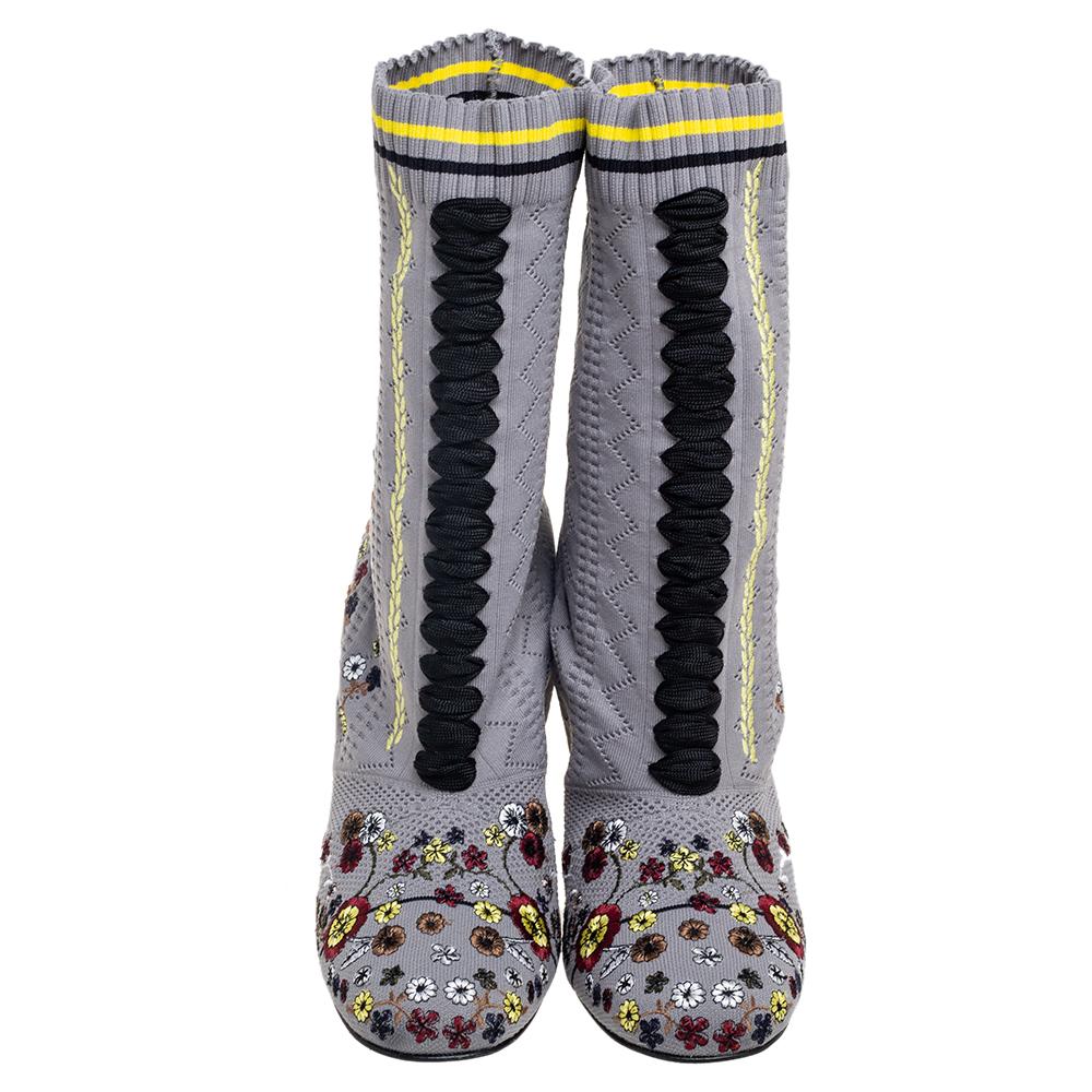 Crafted in Italy, Fendi's boots are stylish, edgy, and sporty. They are knit fabric in a sock-like silhouette adorned with laces, round toes, and a snug fit. These boots are elevated by floral embroideries all over. Style them with a short dress for