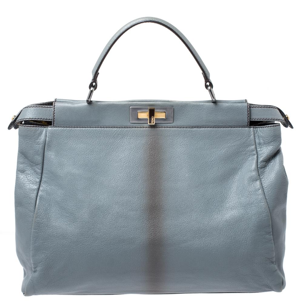 This exquisite grey Peekaboo bag from Fendi is highly coveted, and since its birth in 2009, it has swayed us with its shape, design, and beauty. This version comes meticulously crafted from leather and designed with a top handle for you to swing it.