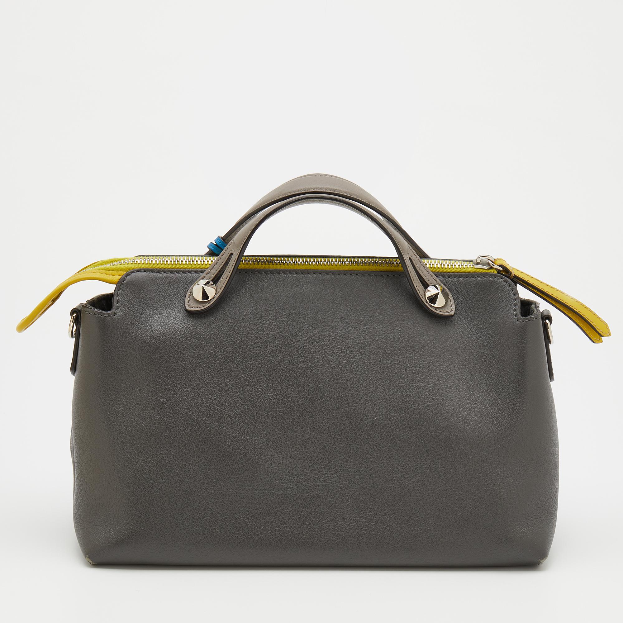 This By The Way bag from Fendi is made from leather. Complemented by silver-tone hardware, it has short handles for a hand-held style. Its main compartment has room for the essentials and is secured by a zip. It is complete with the brand logo