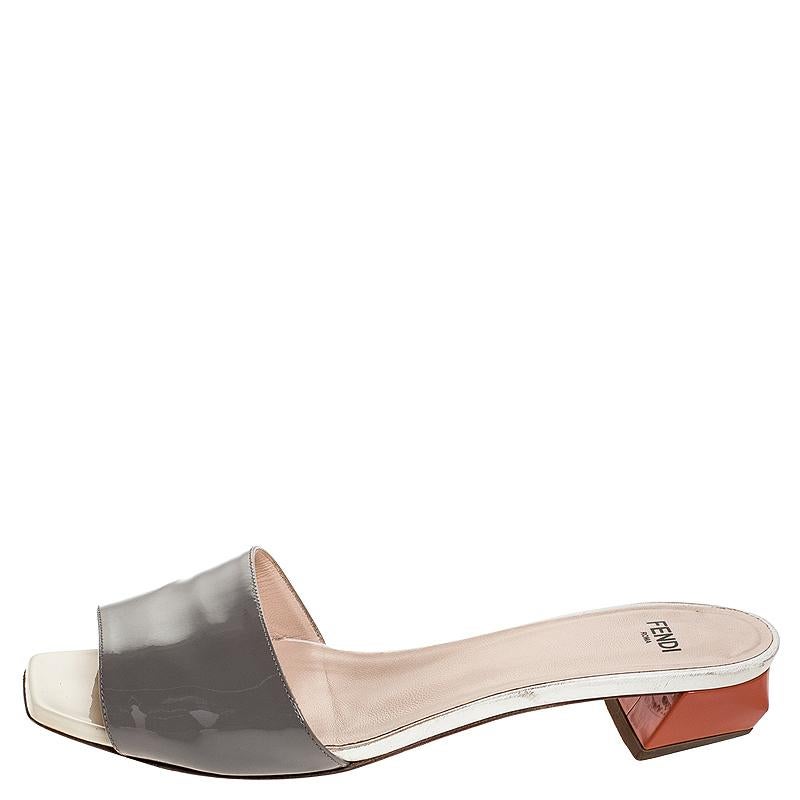 These Fendi slides can be your latest loved purchase. These have been crafted out of grey patent leather and designed with open toes. The insoles are leather-lined and the 2.5cm heels will give you ease.

