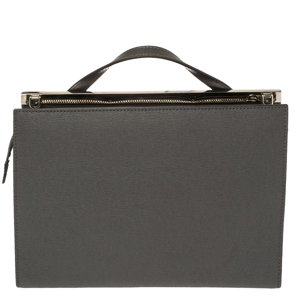 This Demi Jour bag by Fendi is not only lovely to look at, but is also handy and durable. It has been crafted from grey leather and styled very artistically with a flap compartment in the front and a zipper one at the back. The insides are