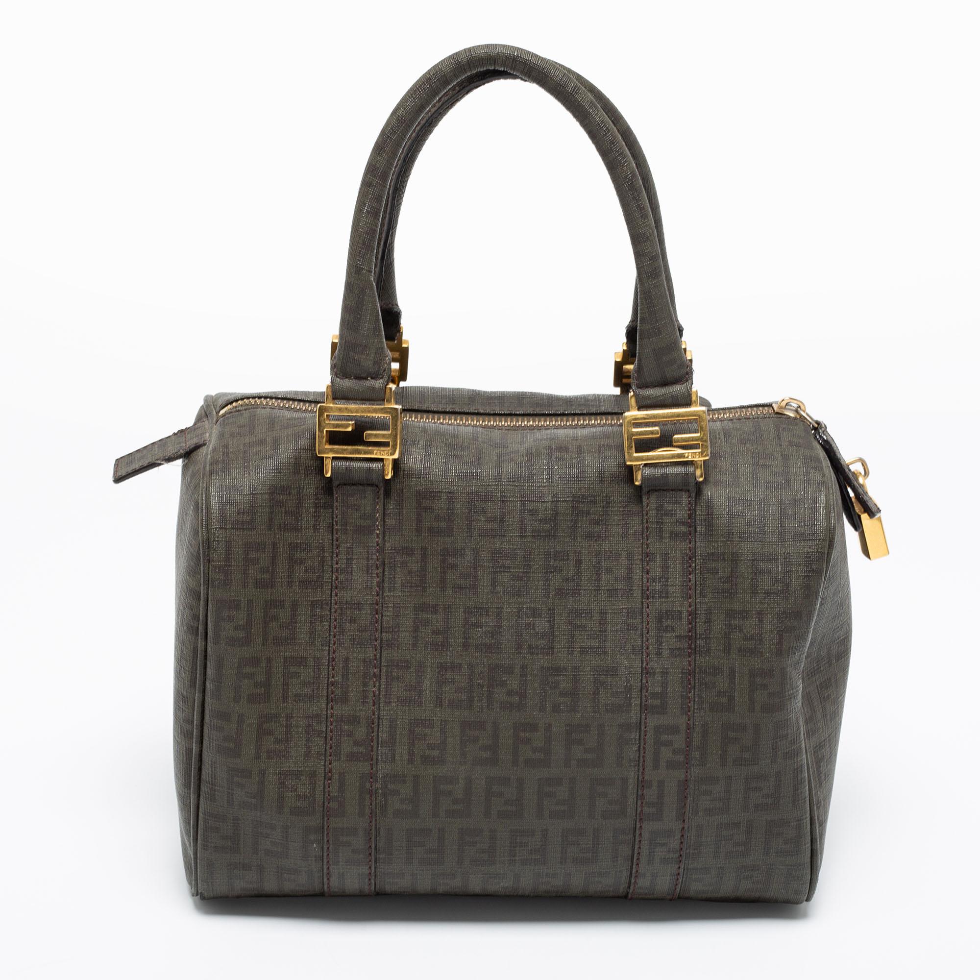 This Forever Bauletto Boston bag from the House of Fendi is both elegant and fashionable. Crafted from grey Zucchino coated canvas, this bag features dual handles, gold-tone hardware, and a fabric-lined interior. Make this stunning Boston bag your