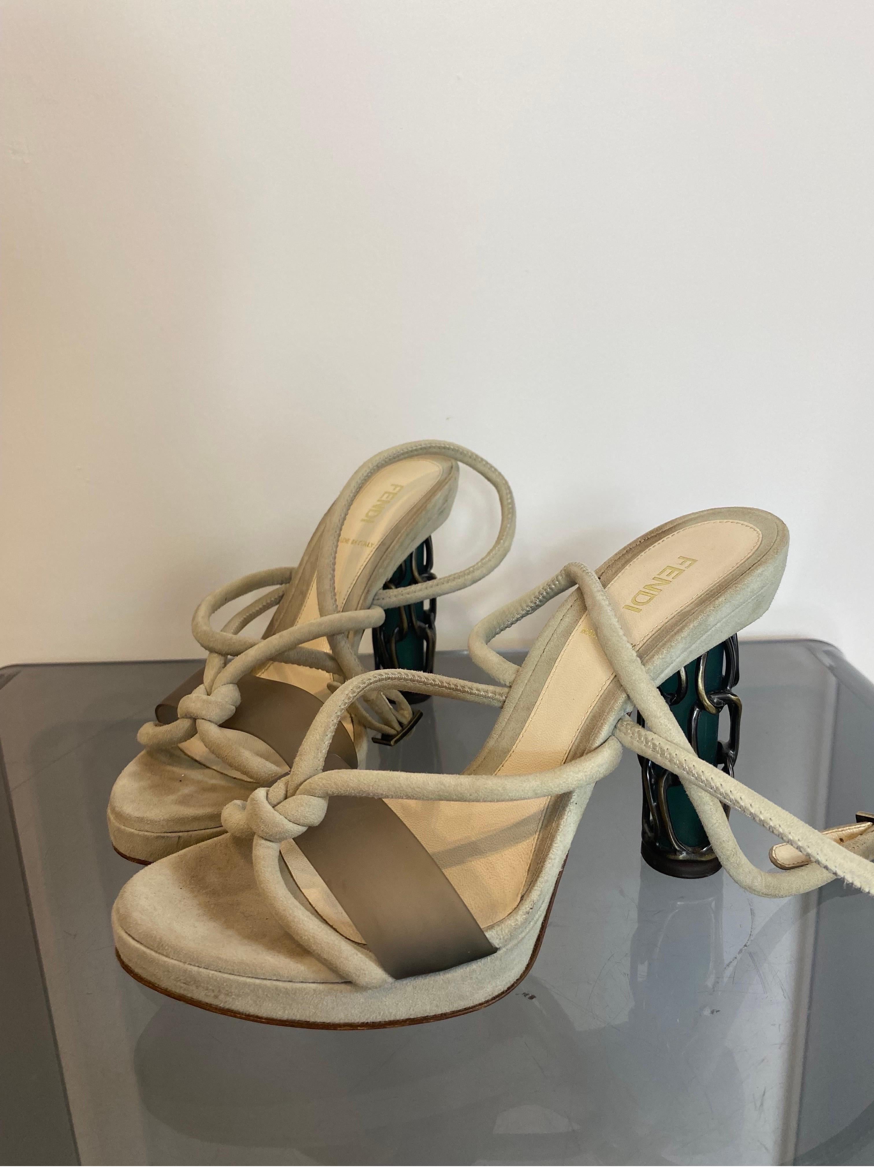 Beige Fendi heel shoe.
SS2008 collection.
In suede. Heel with metal cage.
It ties crosswise on the ankle. 
Number 37.5Ita.
Sole 24 cm.
Heel 9 cm.
Platform 2.5 cm.
In good general condition, they show signs of normal use.
They have a mark as shown in