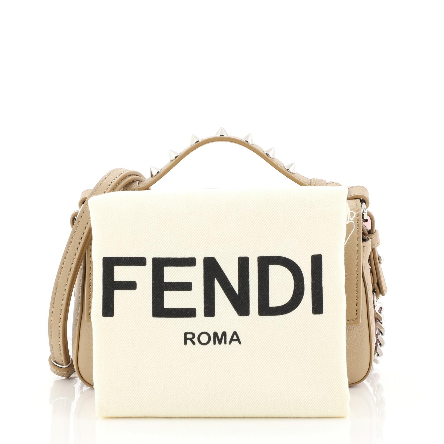 This Fendi Hypnoteyes Double Baguette Crossbody Bag Leather Micro, crafted from brown, pink and multicolor leather, features spiked leather handle, chain link strap with leather pad, distinctive ‘Hypnoteyes’ embellishment on the front, and
