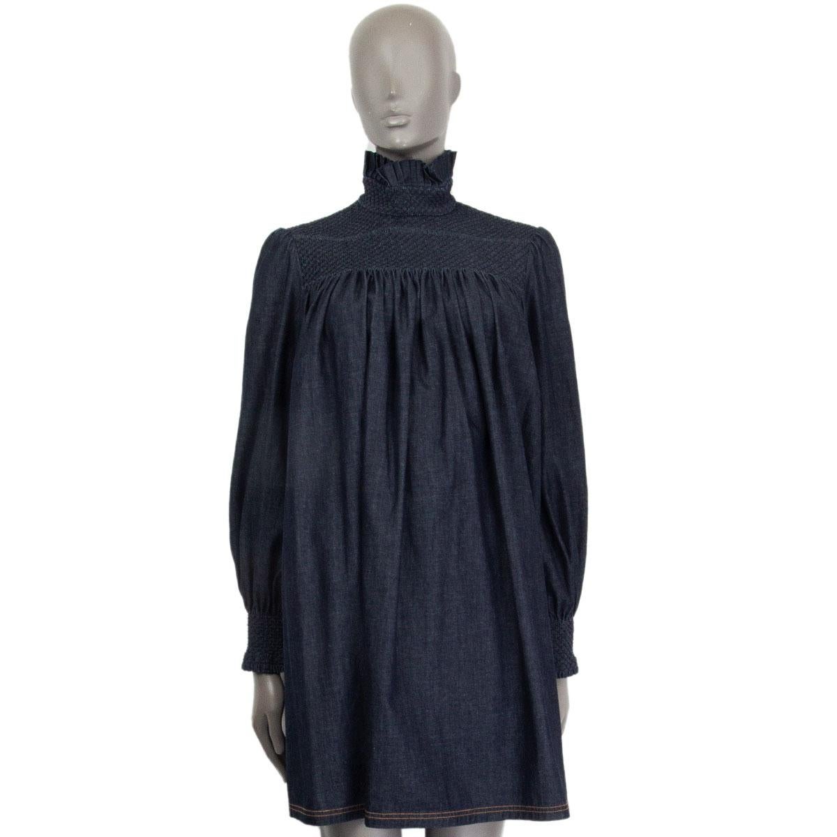 authentic Fendi oversized long sleeve denim dress in indigo cotton (100%). Elastic ruffled shoulder part and cuffs. Two slit-pockets on the side and pleated stand-up collar. Has been worn once and is in excellent condition. 

Tag Size 42
Size