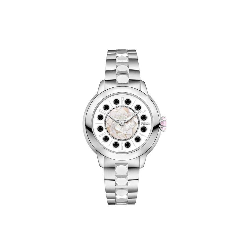 FENDI ISHINE WHITE 33 MM F121024500T01
*This watch consists of interchangeable hour markers.
Rotating gemstones mechanism activated by the twist of the crown.

Gender: Women's 
Condition: Brand-New with Box, Papers & Booklet
Warranty: 2 years