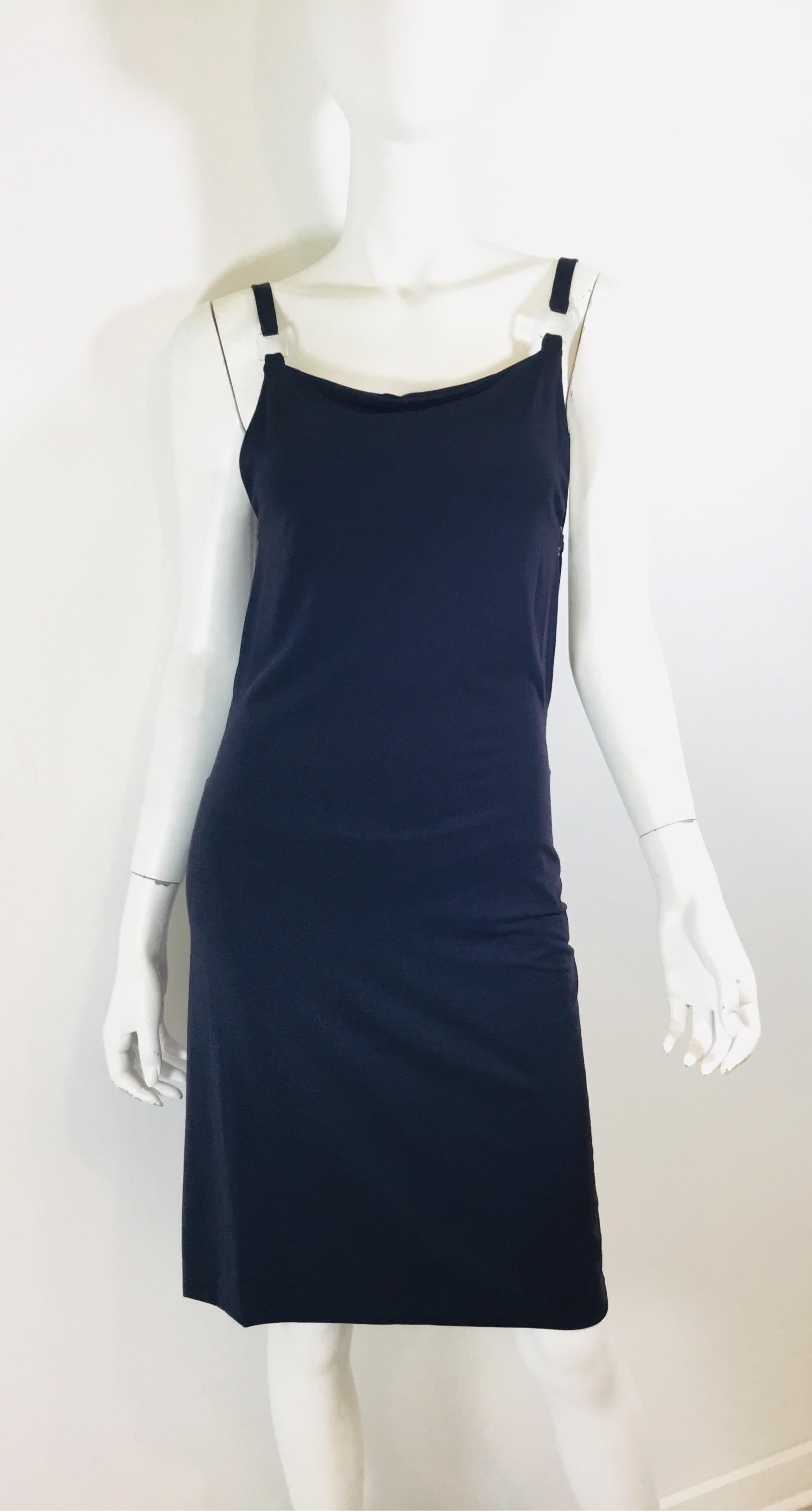 Fendi Dress is featured in a navy colored jersey knit with clear Lucite blocks attaching the shoulder straps and cutout side panels. Dress is a size 40, made in Italy.

Measurements:
Bust 28”
Waist 29”
Hips 31”
Length 35”
*jersey fabric has generous