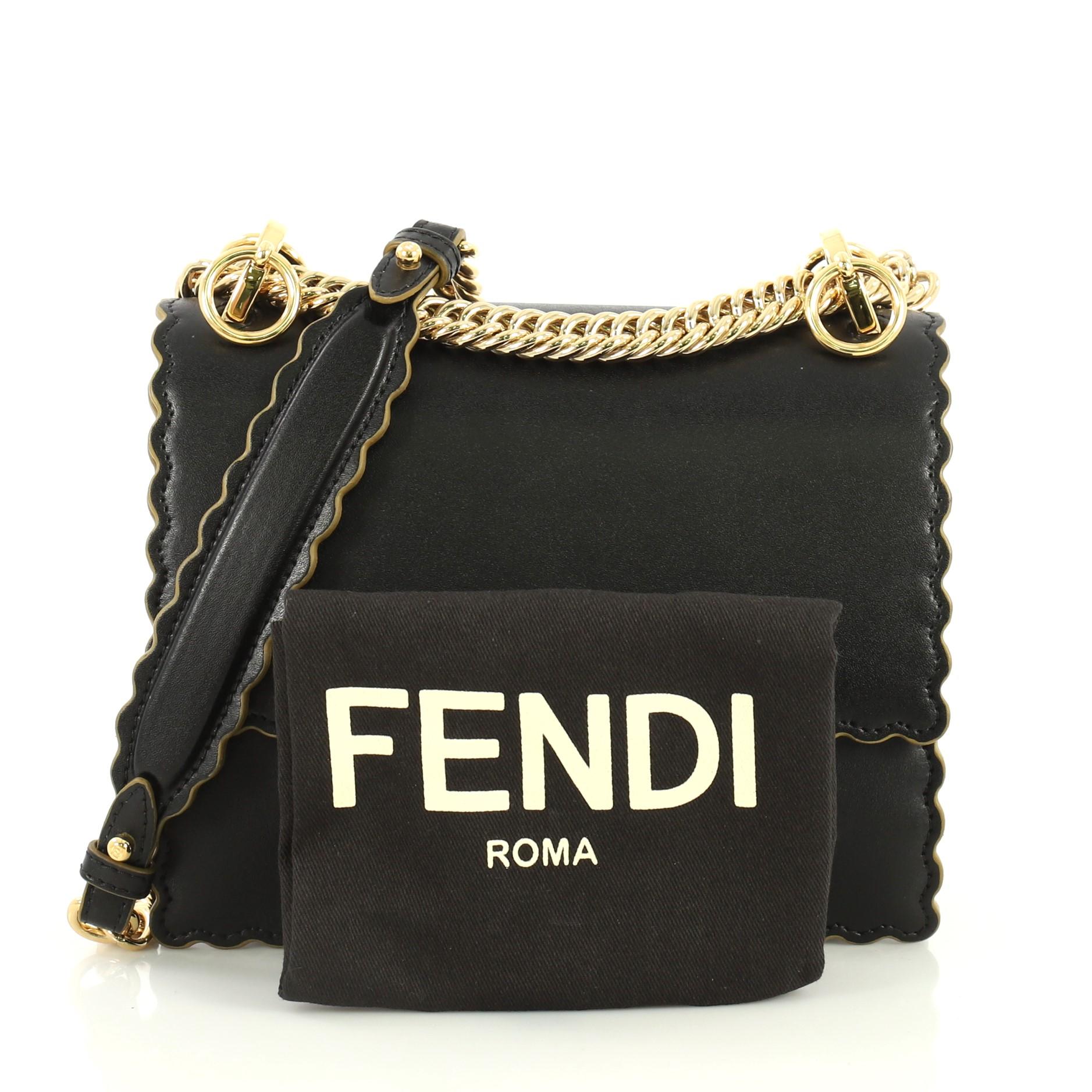 This Fendi Kan I Bag Leather Small, crafted from black leather, features sliding chain link shoulder strap with leather insert and gold-tone hardware. Its twist-lock closure opens to a neutral microfiber interior divided into two compartments with